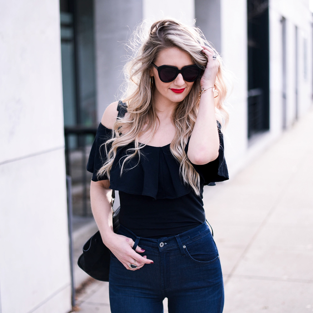 Black ruffle top and high waisted flared jeans. 