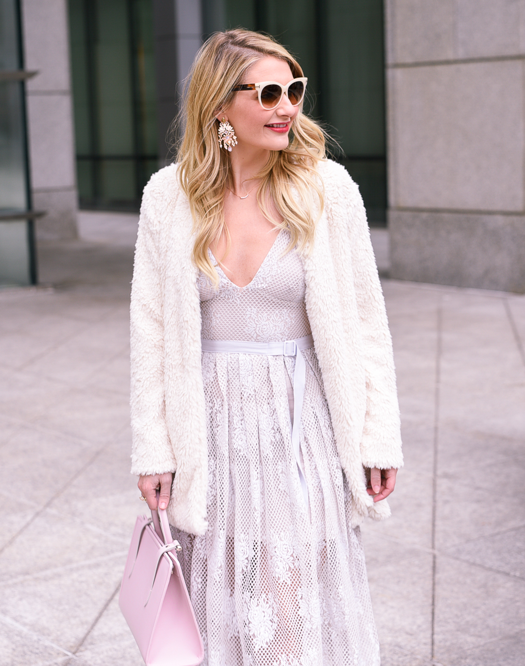 Faux fur white coat with a belted pastel blue midi dress. 