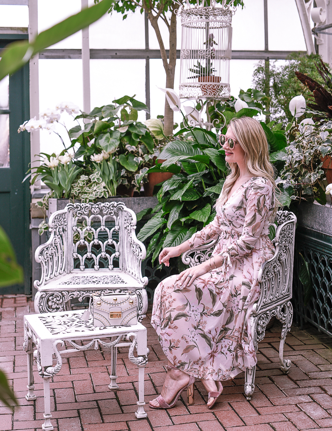 Cute white iron chairs in a winter garden greenhouse in Asheville, North Carolina. 