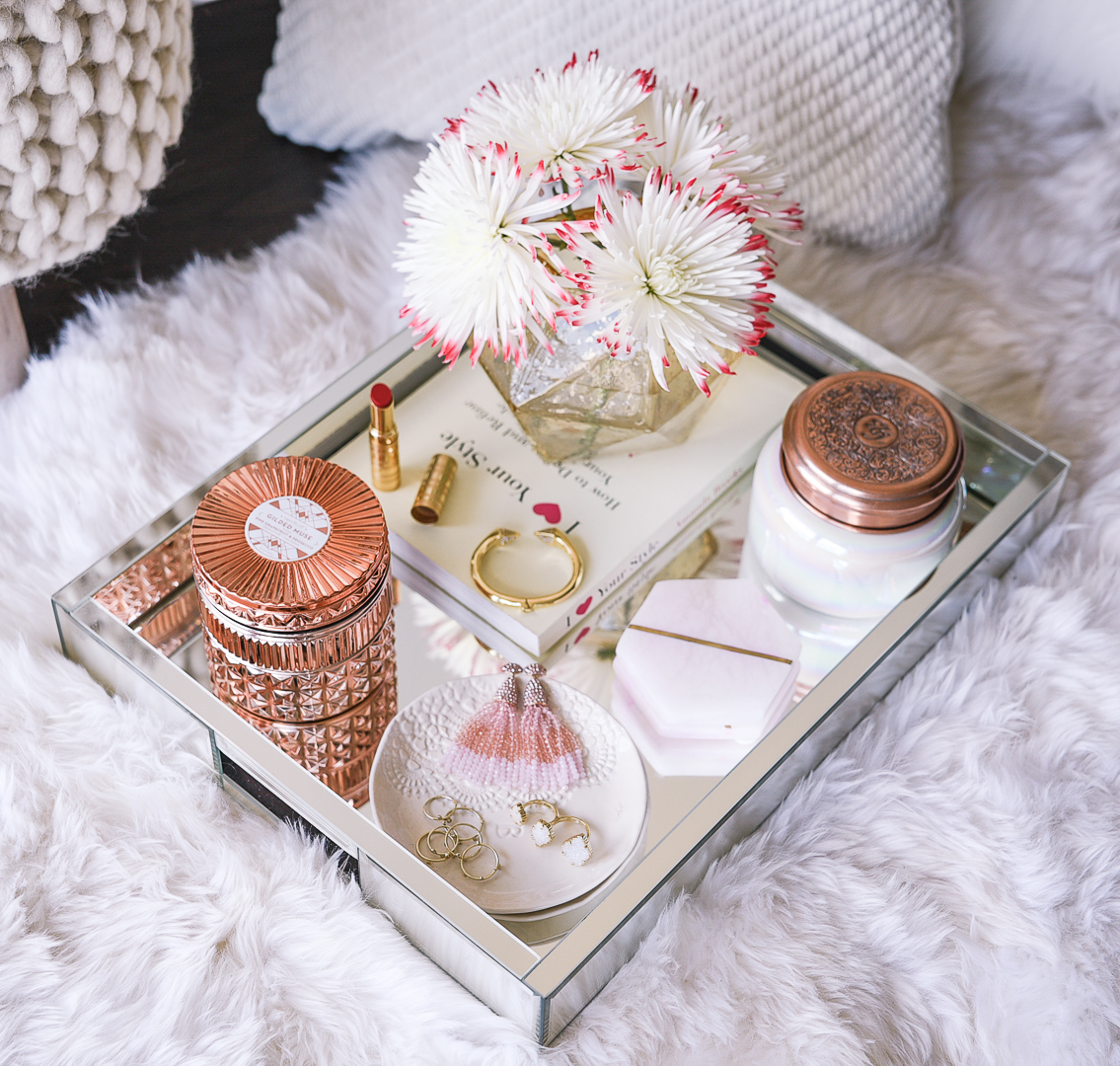 Mirrored coffee table tray and rose gold Capri Blue candle. 