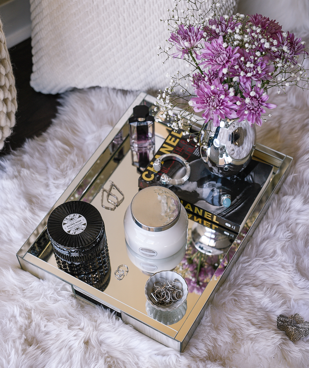 Black Capri Blue candle on a mirrored coffee table tray. 