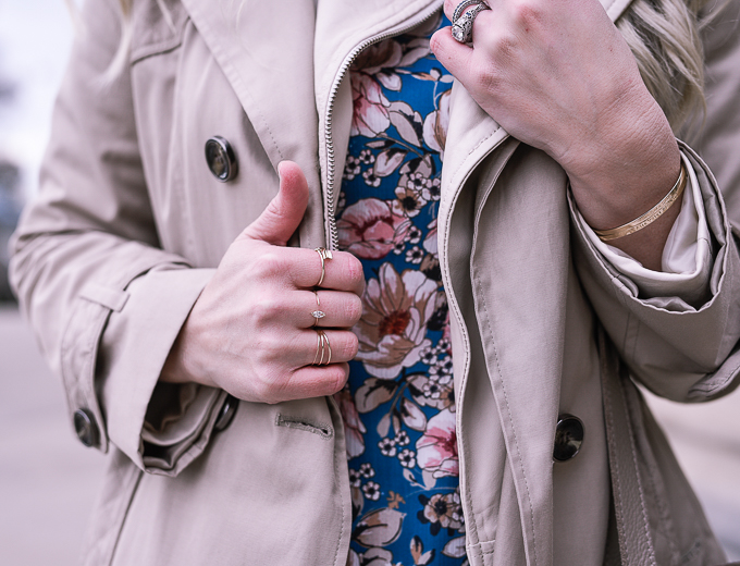 Dainty gold ring stack and a teal floral dress. 