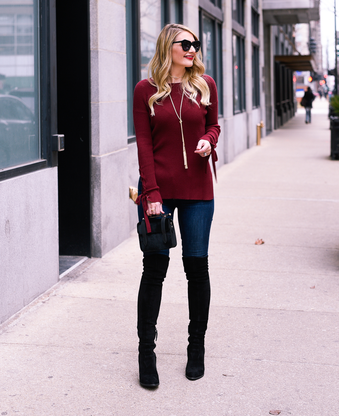 Over the knee boots and a red lace up sweater. 