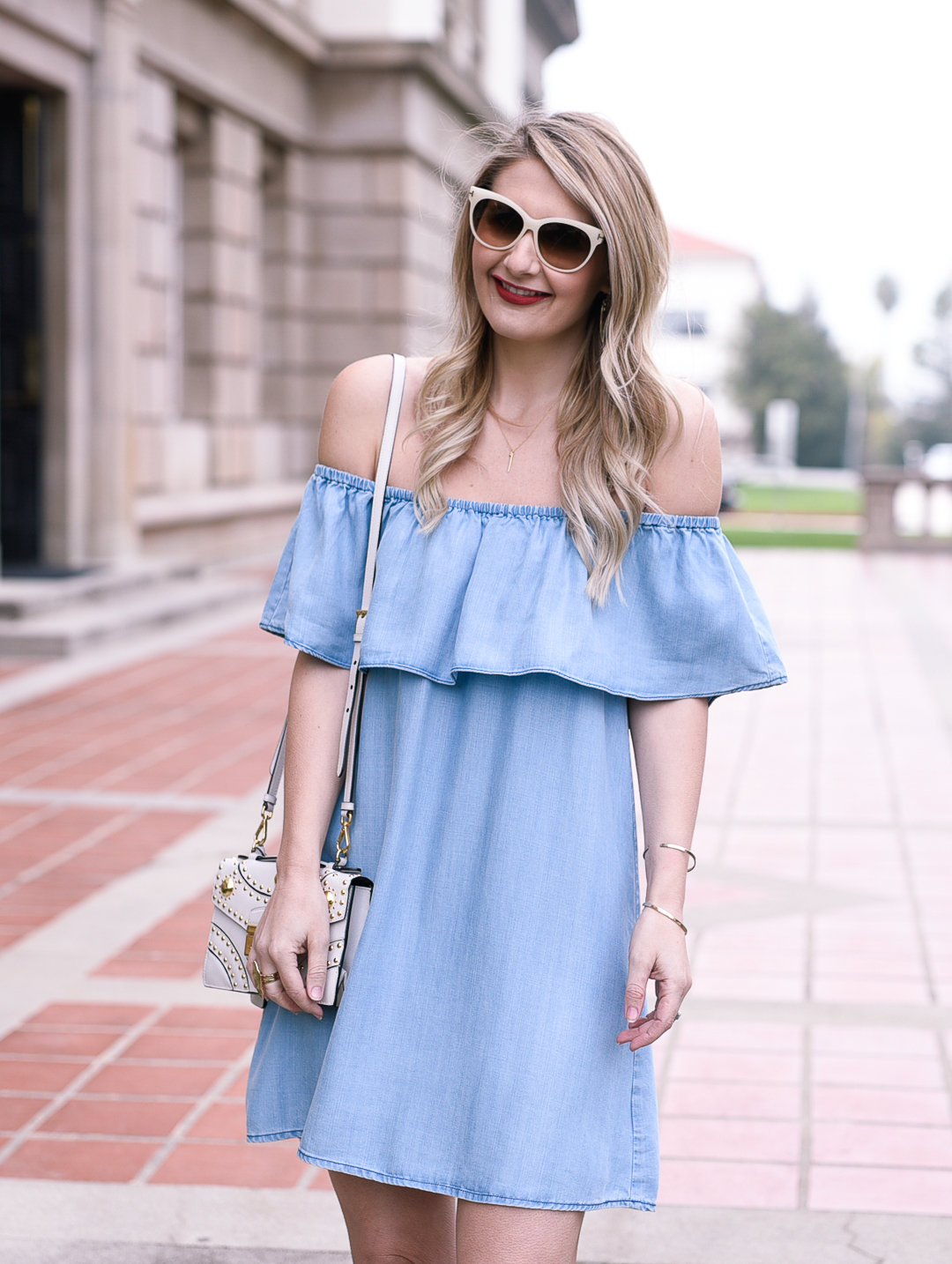 Twirling in this lightweight denim dress with a cute ruffle hem.