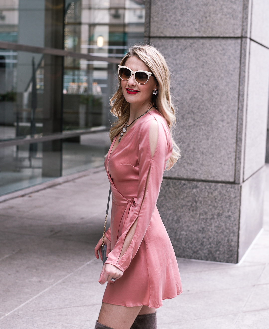 A fit and flare blush pink dress with a tie waist