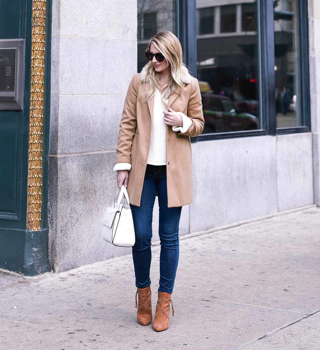 Beige colored jacket with fringe boots. 