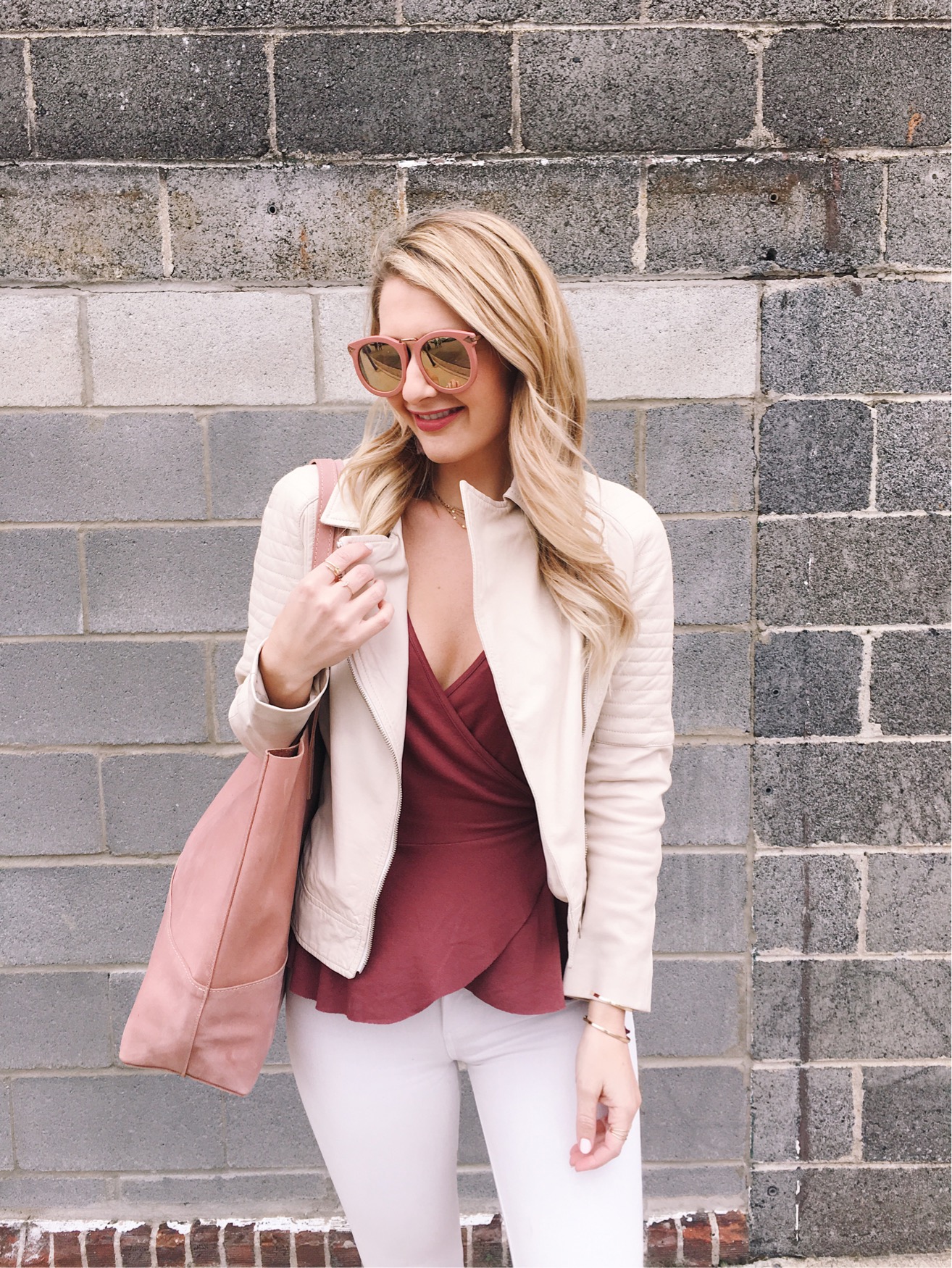 Wrap ruffled top in burgundy with a white moto jacket and pink sunnies!