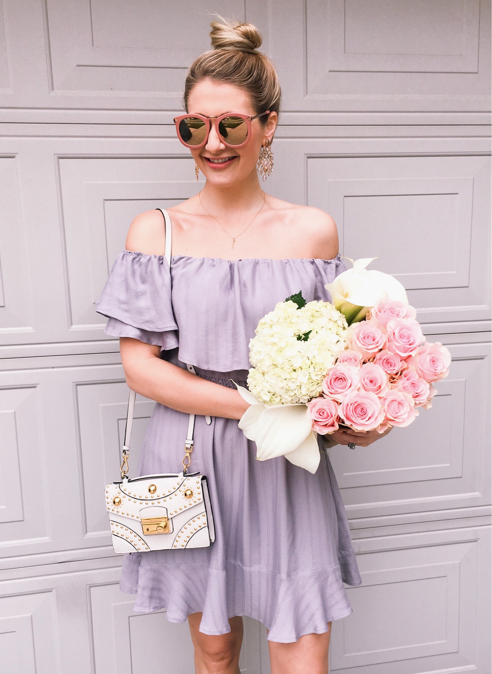 Blue ruffled off the shoulder dress and flower arrangement. 