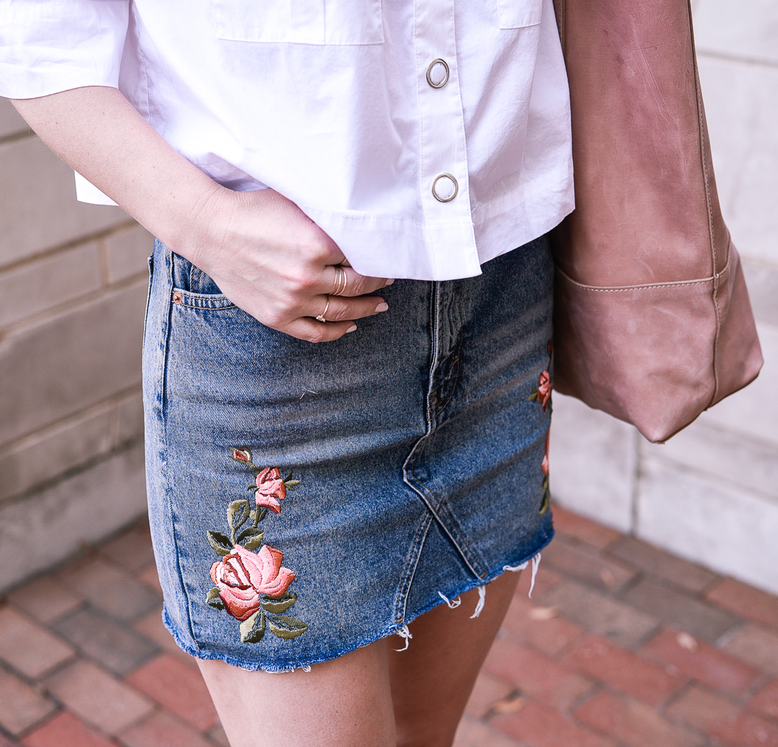 embroidered floral skirt with taupe wedges and a pink tote bag