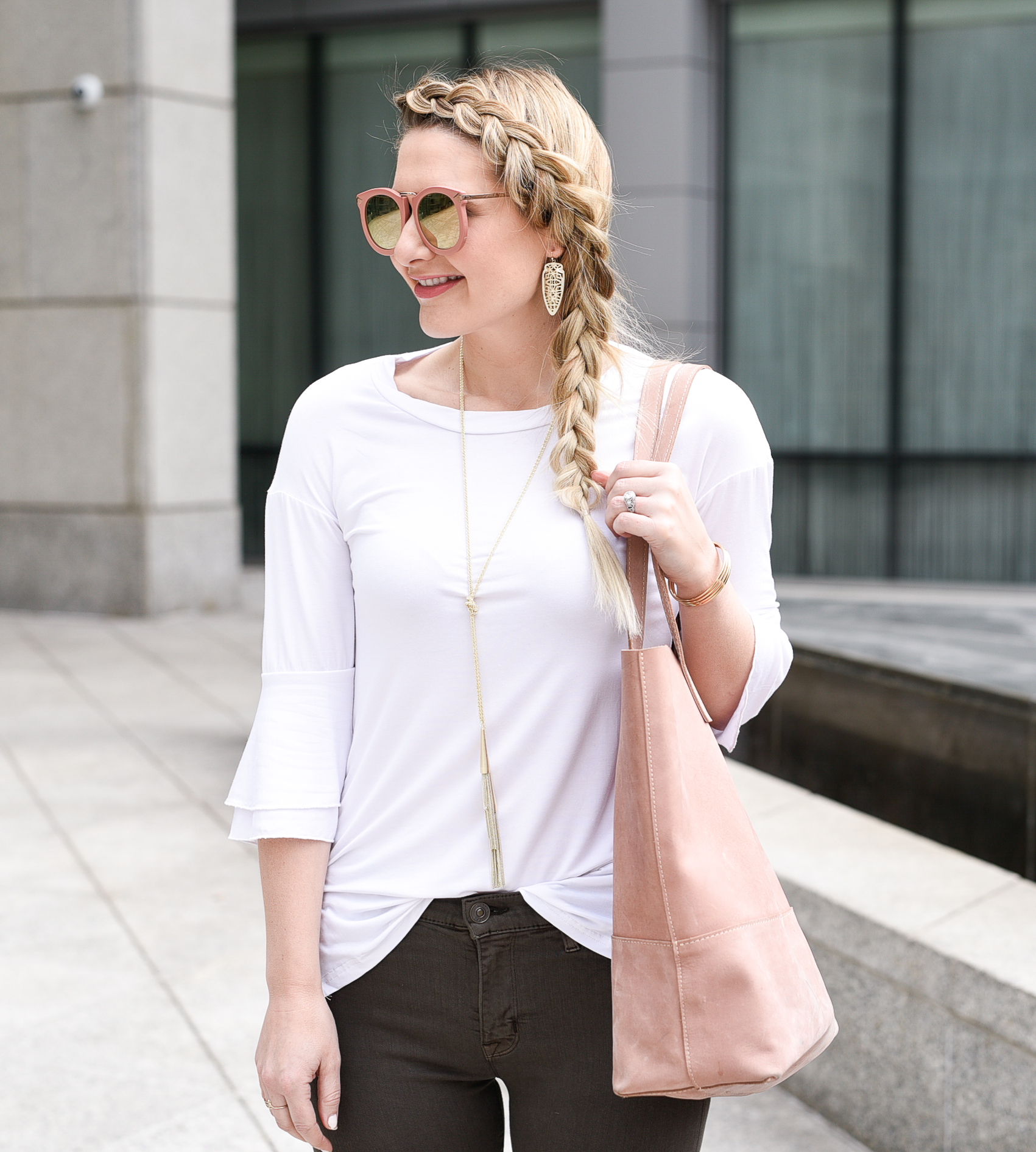 White t-shirt with bell sleeves and ruffles. 