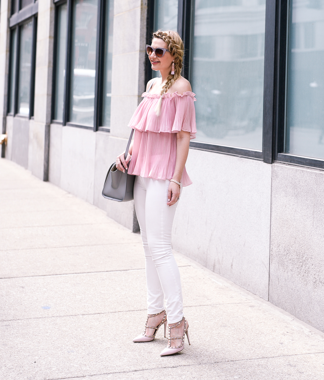 Pink ruffled top and white skinny jeans. 