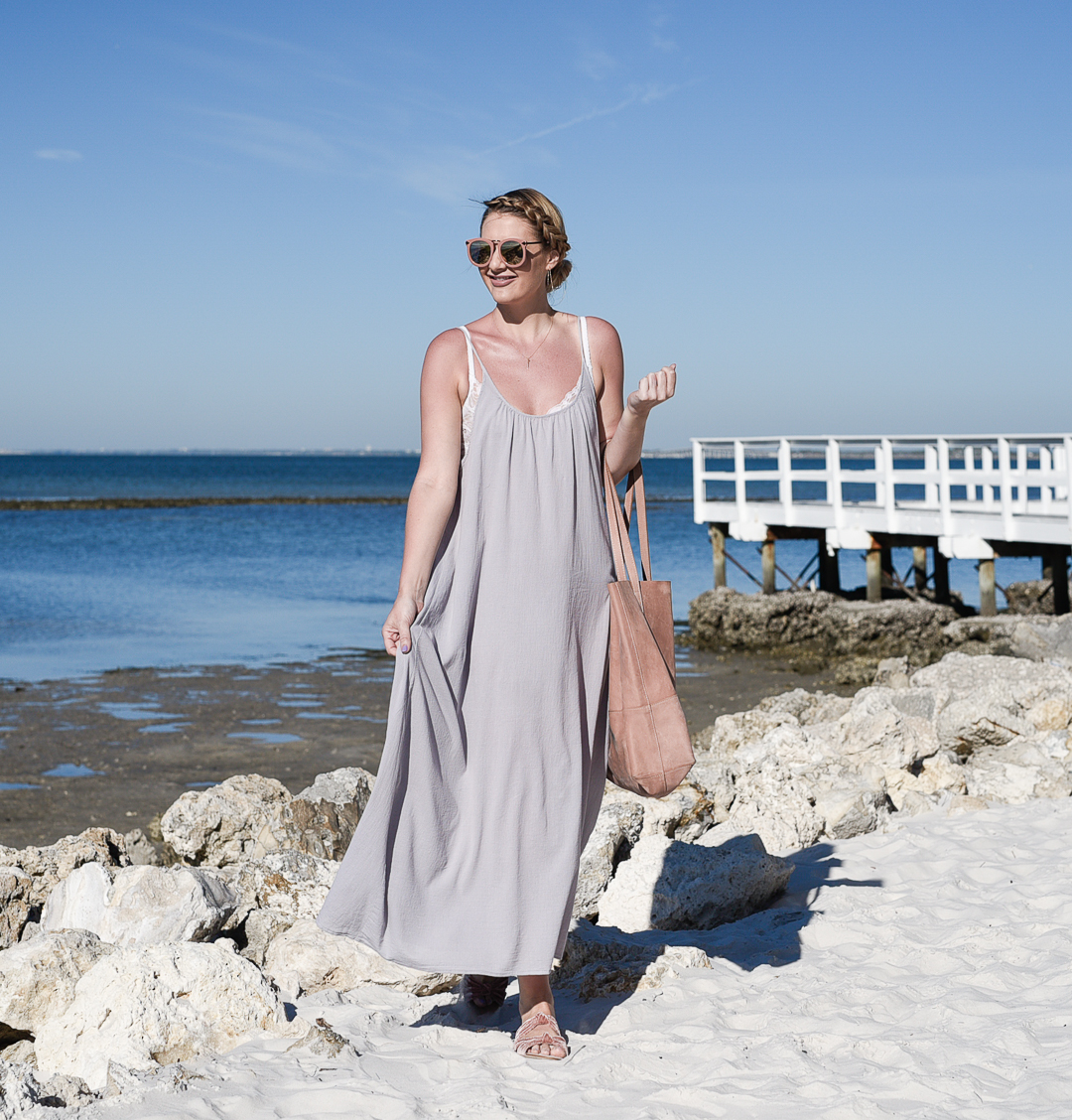 pink sunglasses and a grey coverup maxi dress