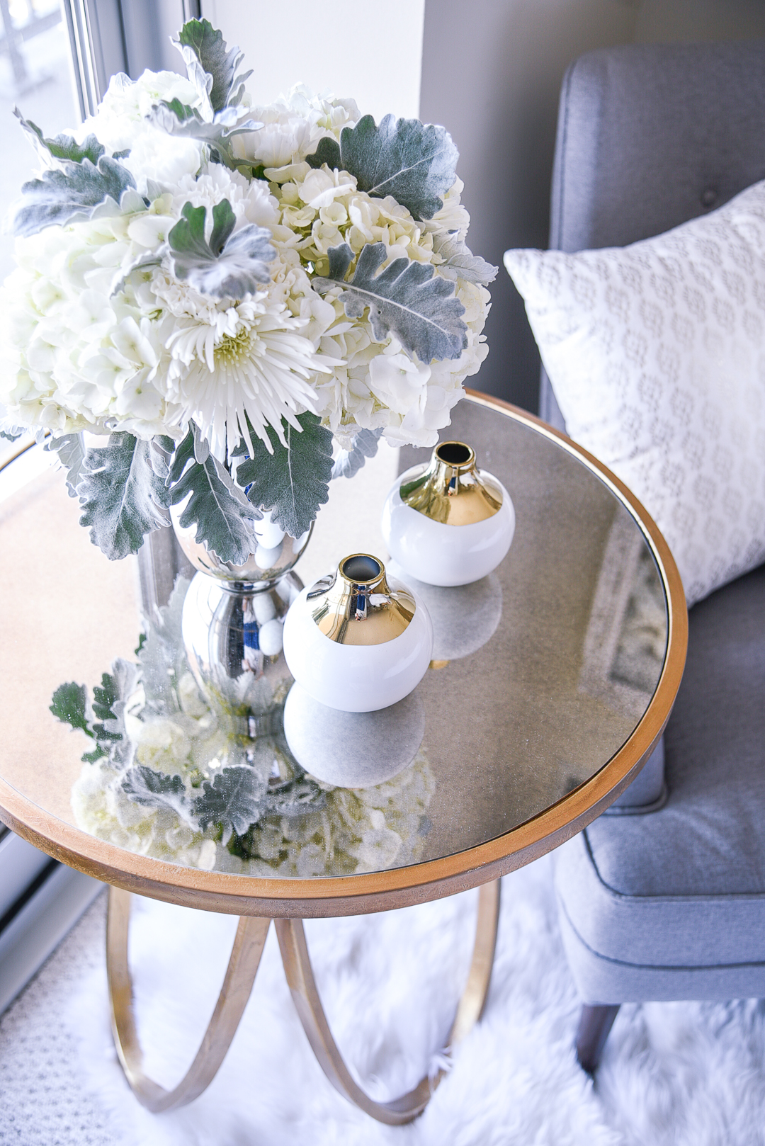 A white bouquet in a vase with lamb's ear leaves and hydrangeas