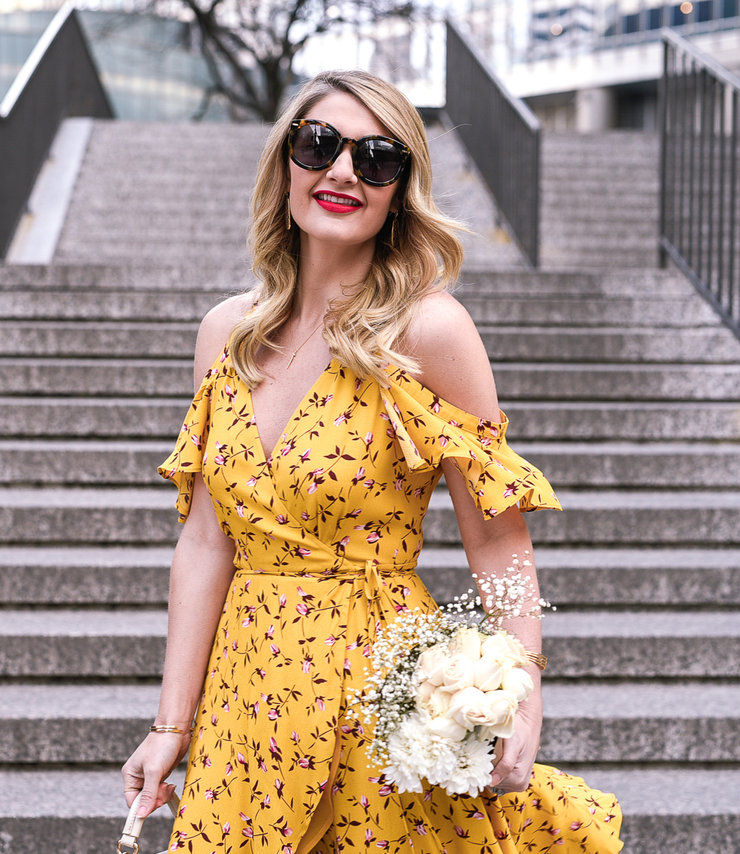 Bright yellow dress with a cold shoulder ruffled sleeve and white roses. 