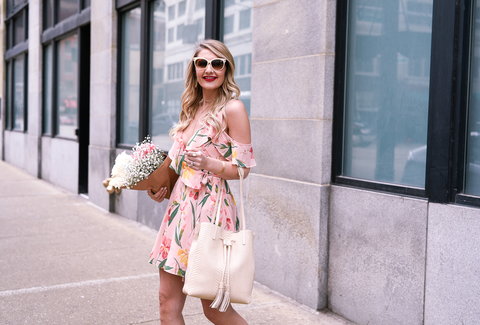 Jenna Colgrove wearing the Privacy Please x Revolve Hamlet floral wrap dress in pink.