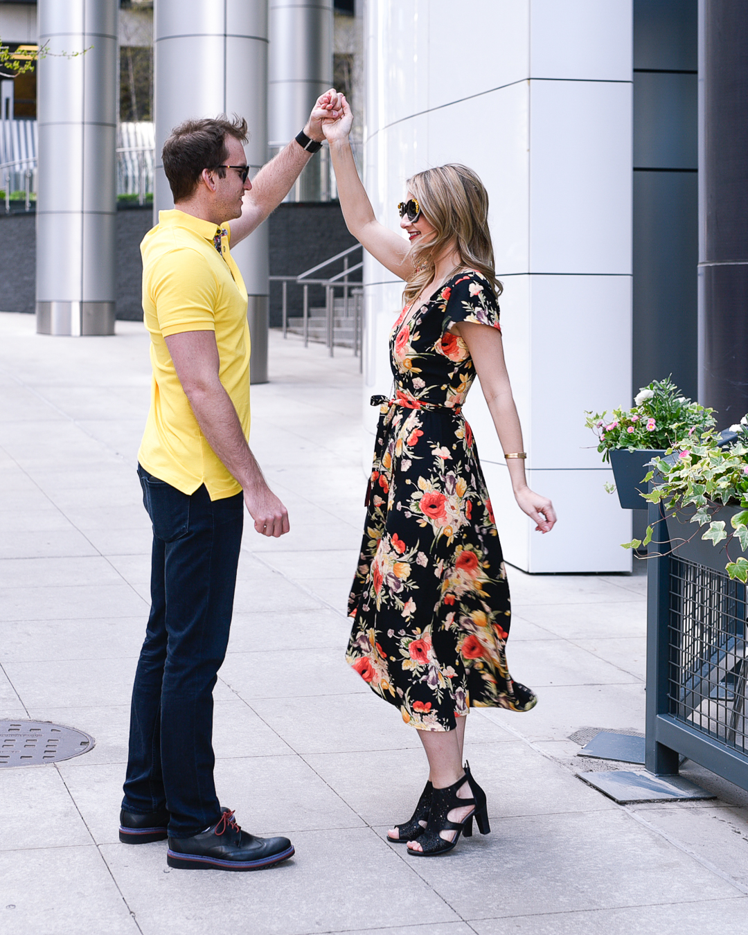 Twirling in a black, yellow, and orange wrap dress for spring. 