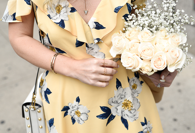 Mejuri Lines Collection gold rings with white roses and a gold Y necklace. 