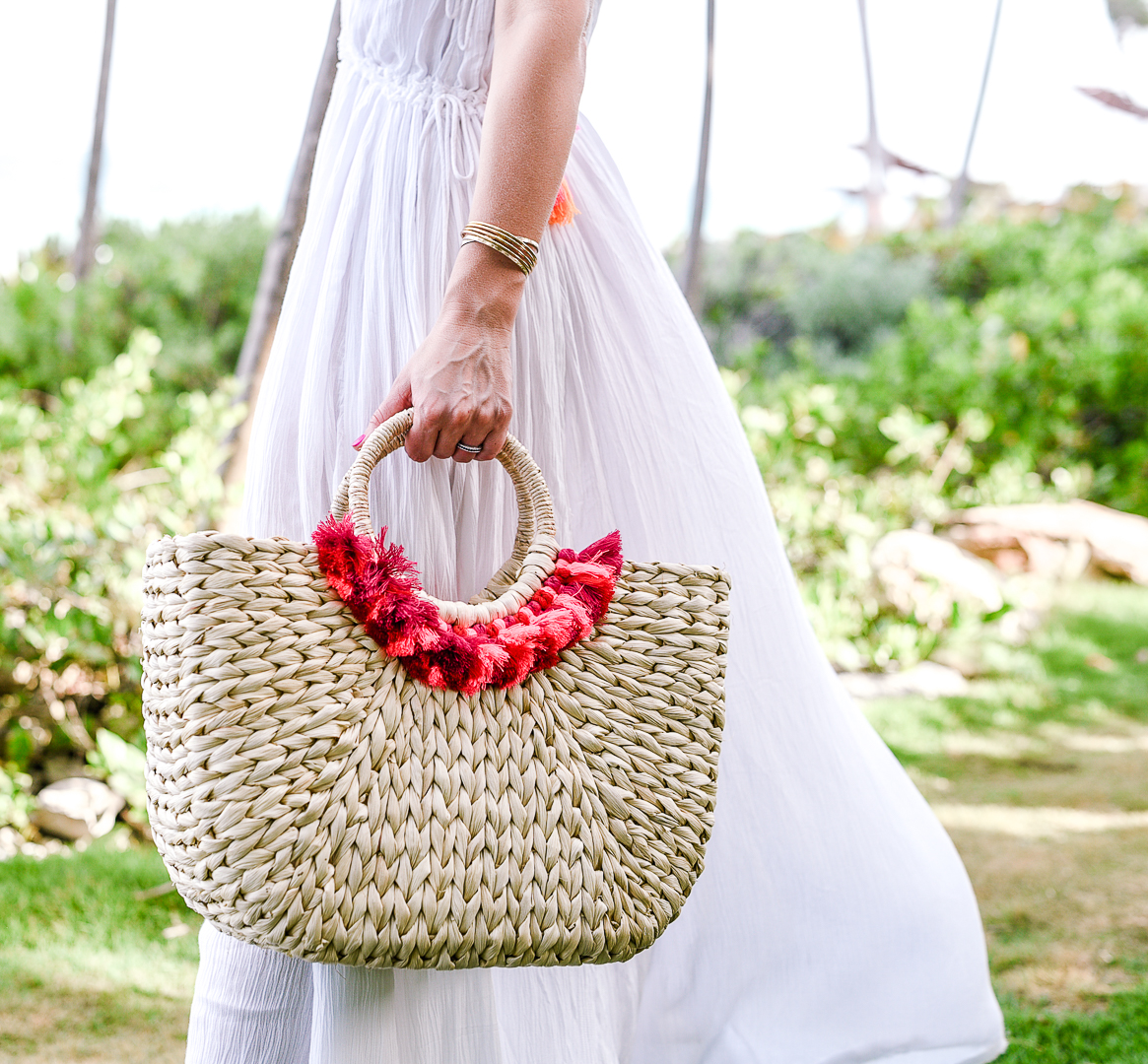 straw tote by hat attack with red and orange tassels