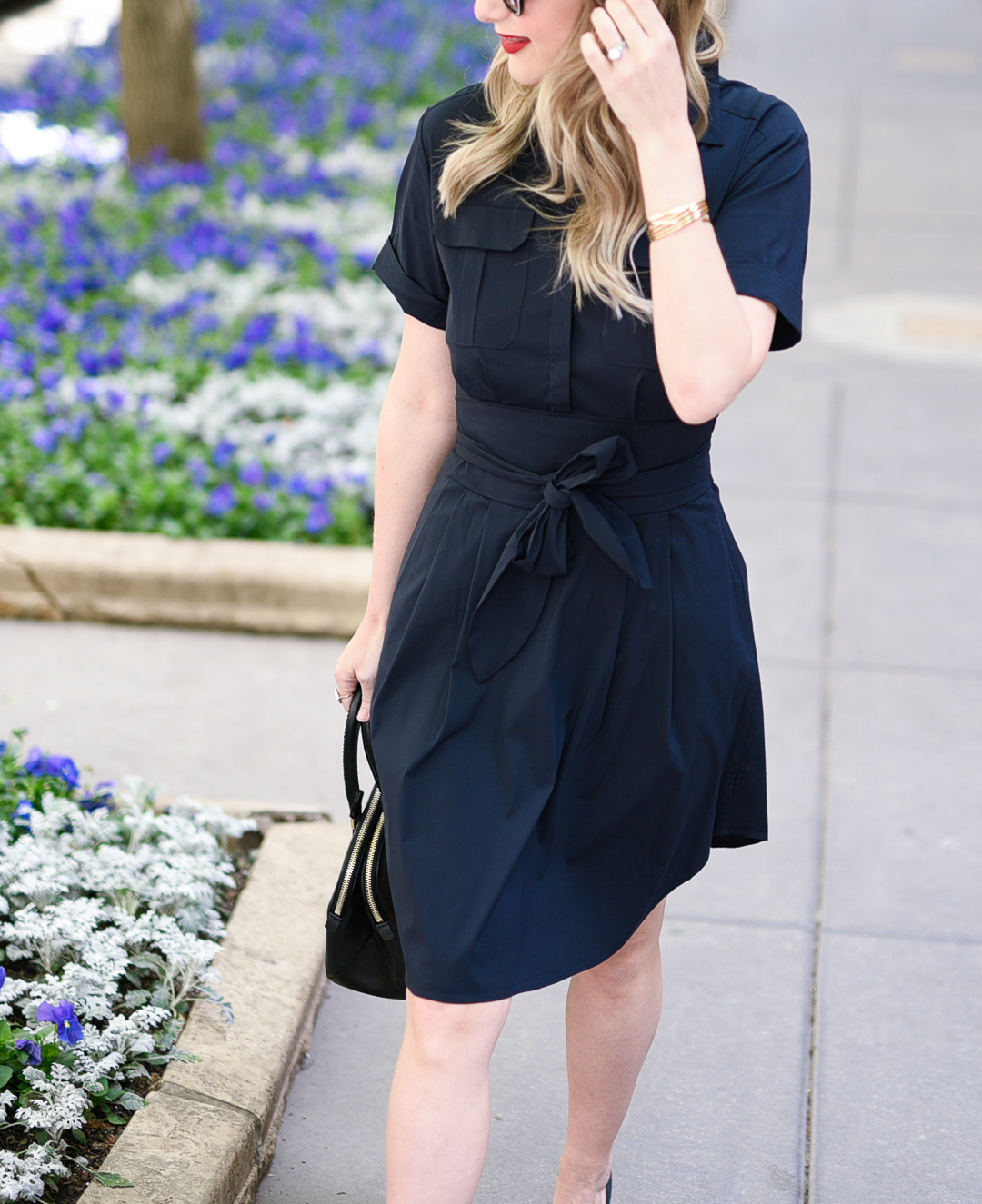 a navy blue shirtdress with a bow belt