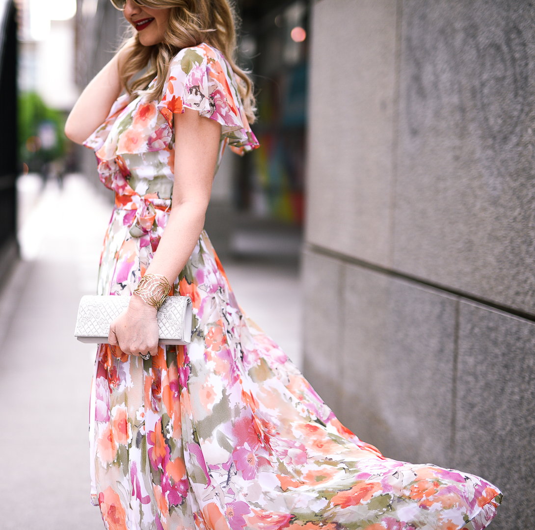 Orange, pink, and white floral dress with a silver beaded clutch. 