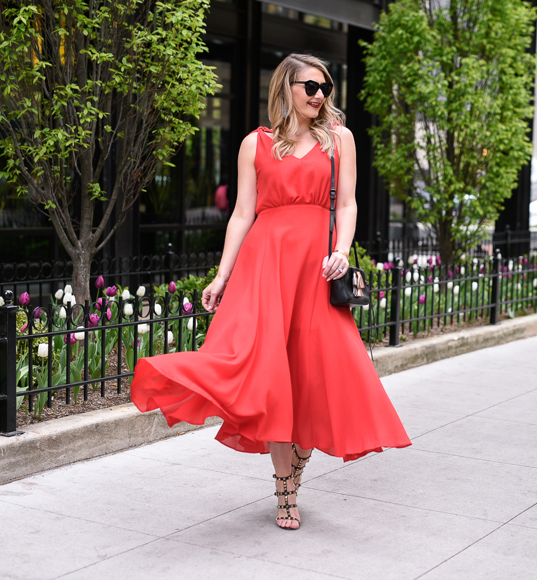 A flattering red dress for work with a long, flowy skirt. 