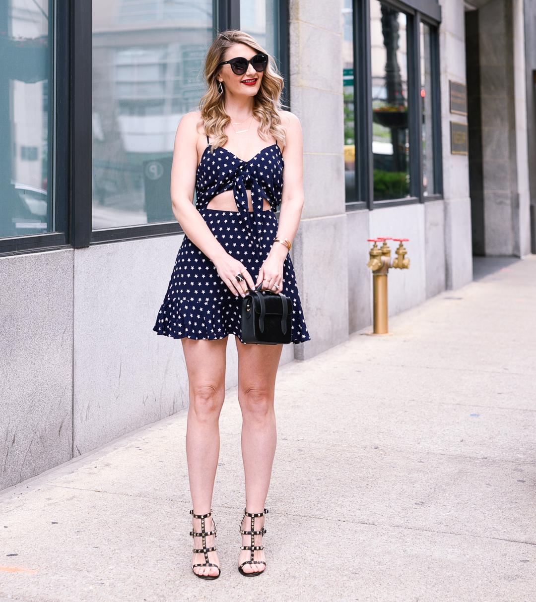 A navy dress with a cut out at the waist perfect for summer outfit inspiration
