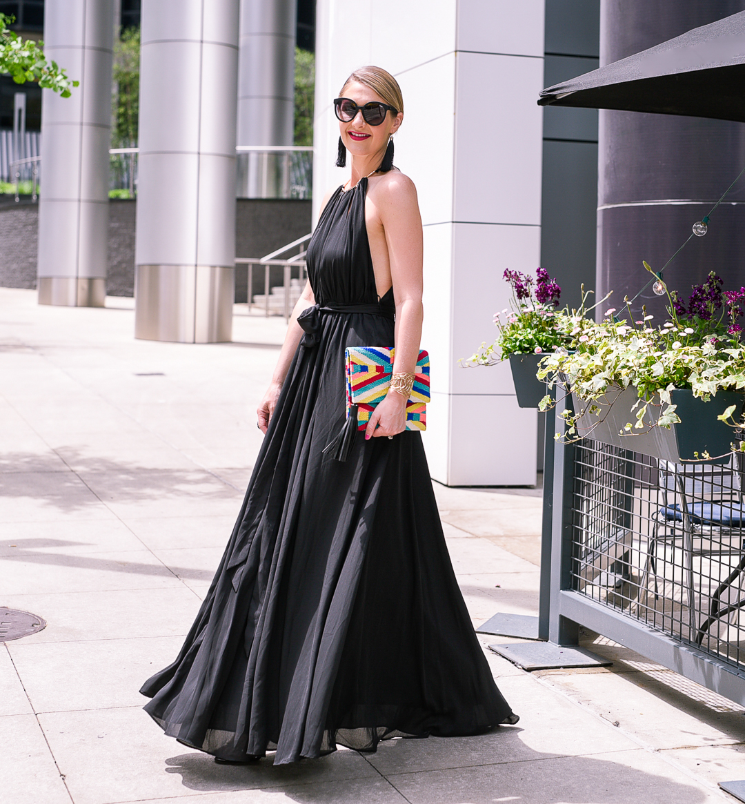 A woman wearing a black off-the-shoulder dress