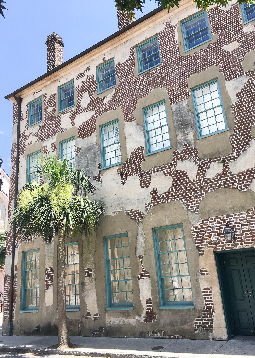 exposed brick home with blue shutters