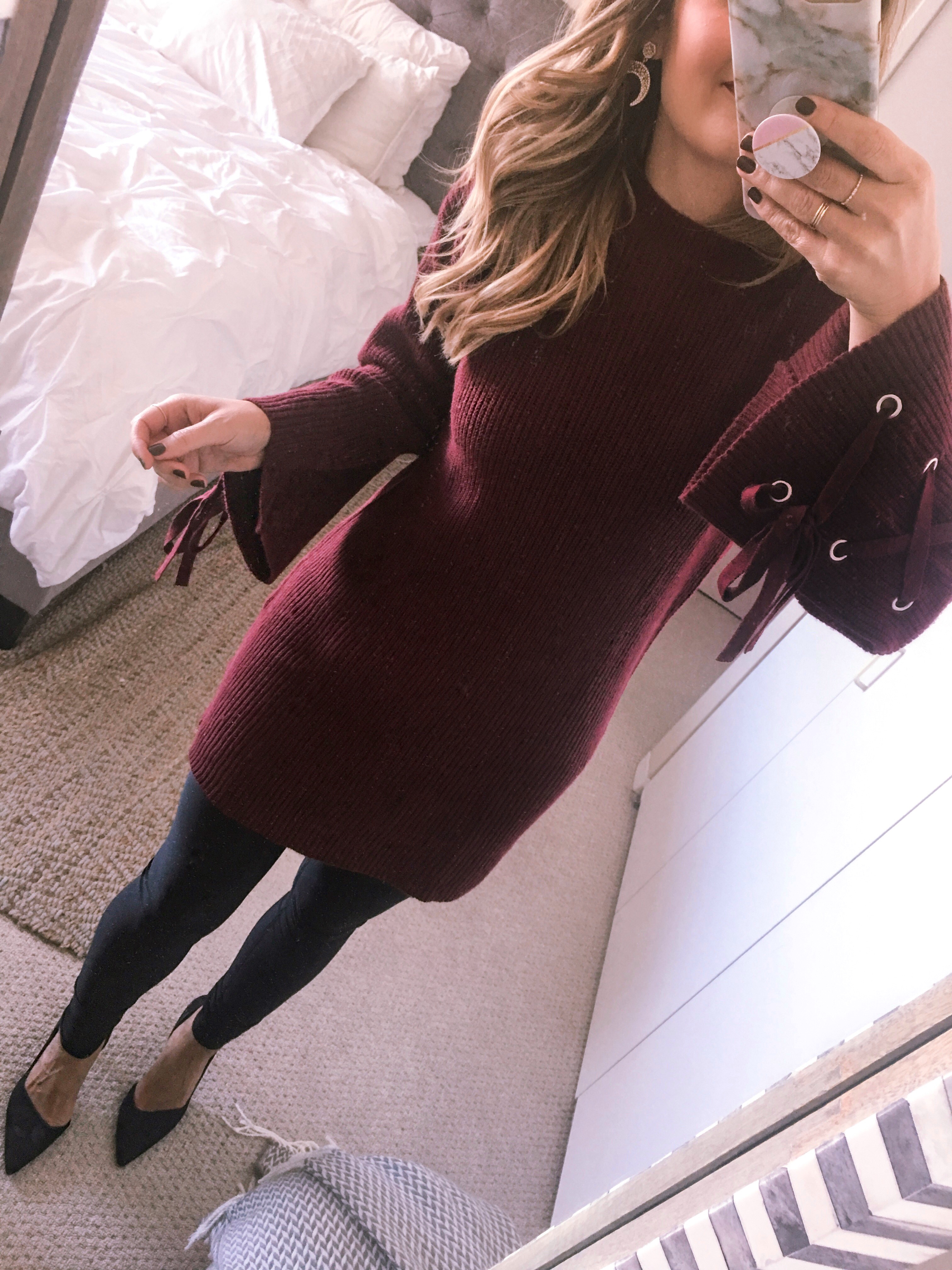 burgundy sweater dress with lace up sleeves and faux leather leggings