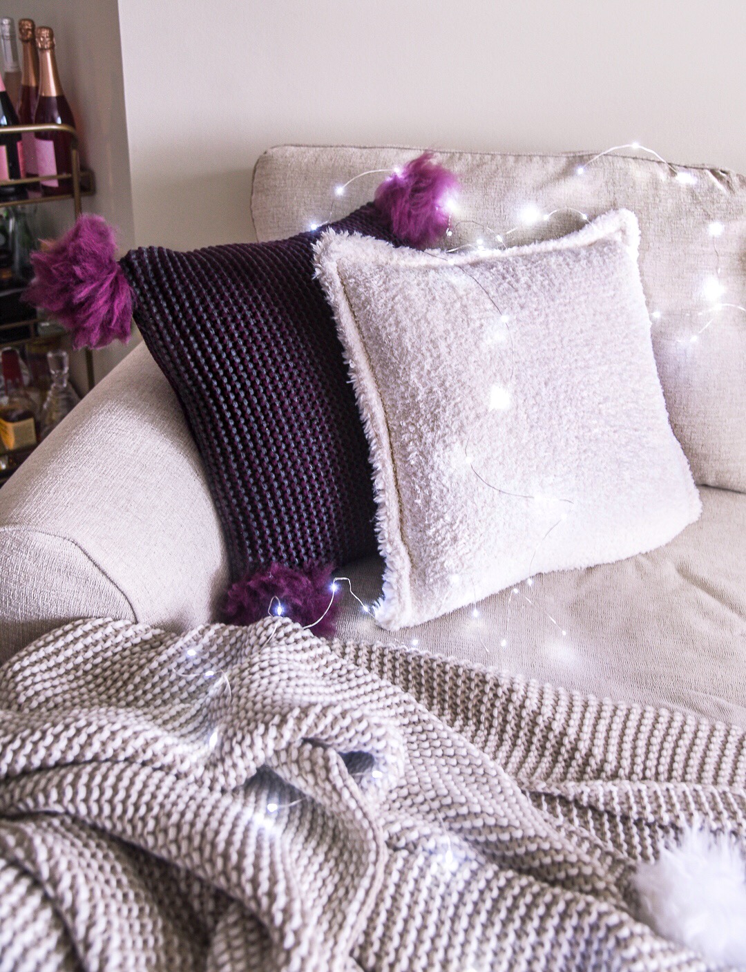 Burgundy pom pom pillow from UGG at Nordstrom - how to decorate a cozy home by Chicago style blogger Visions of Vogue