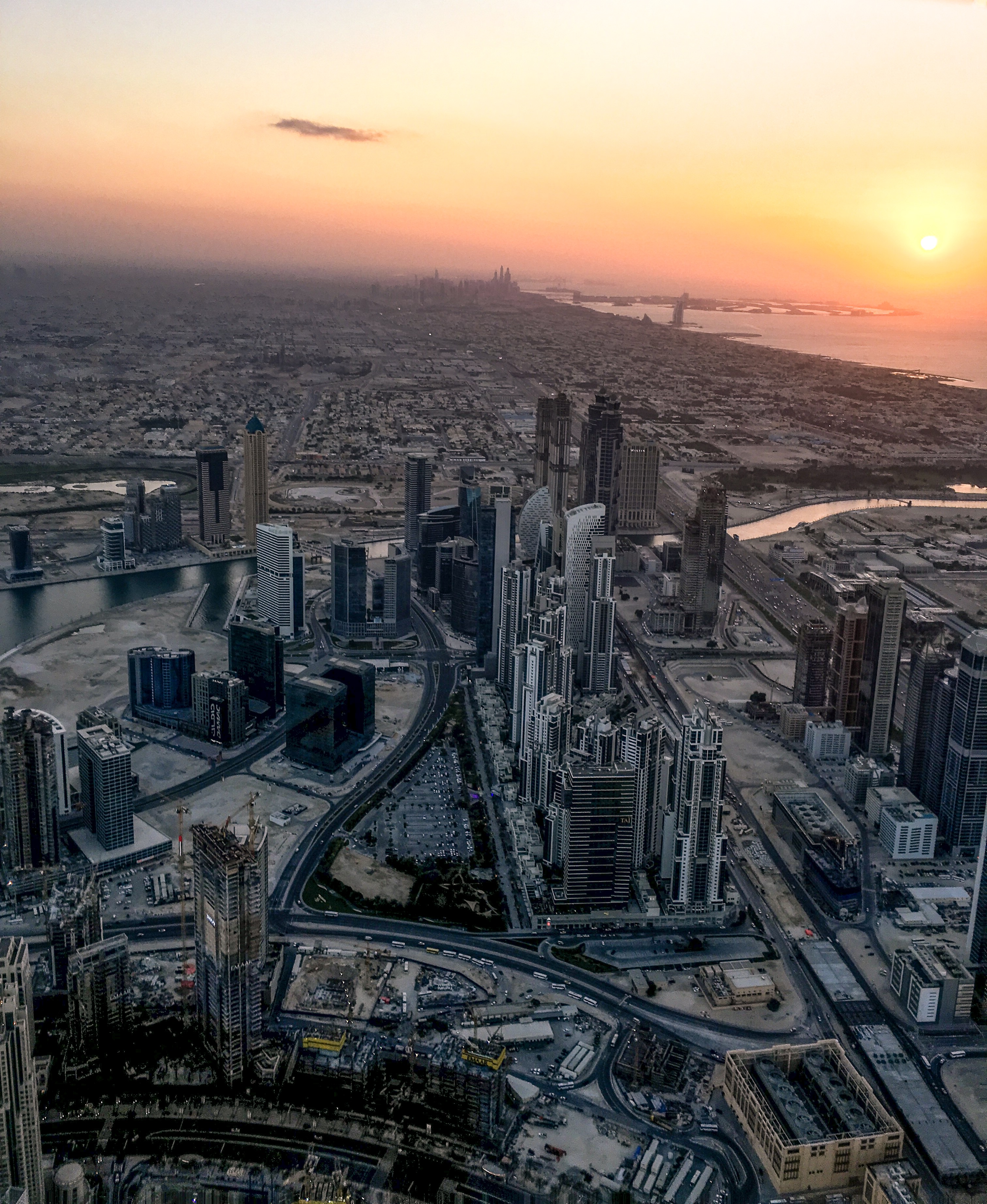 view from burj khalifa of sunset in dubai