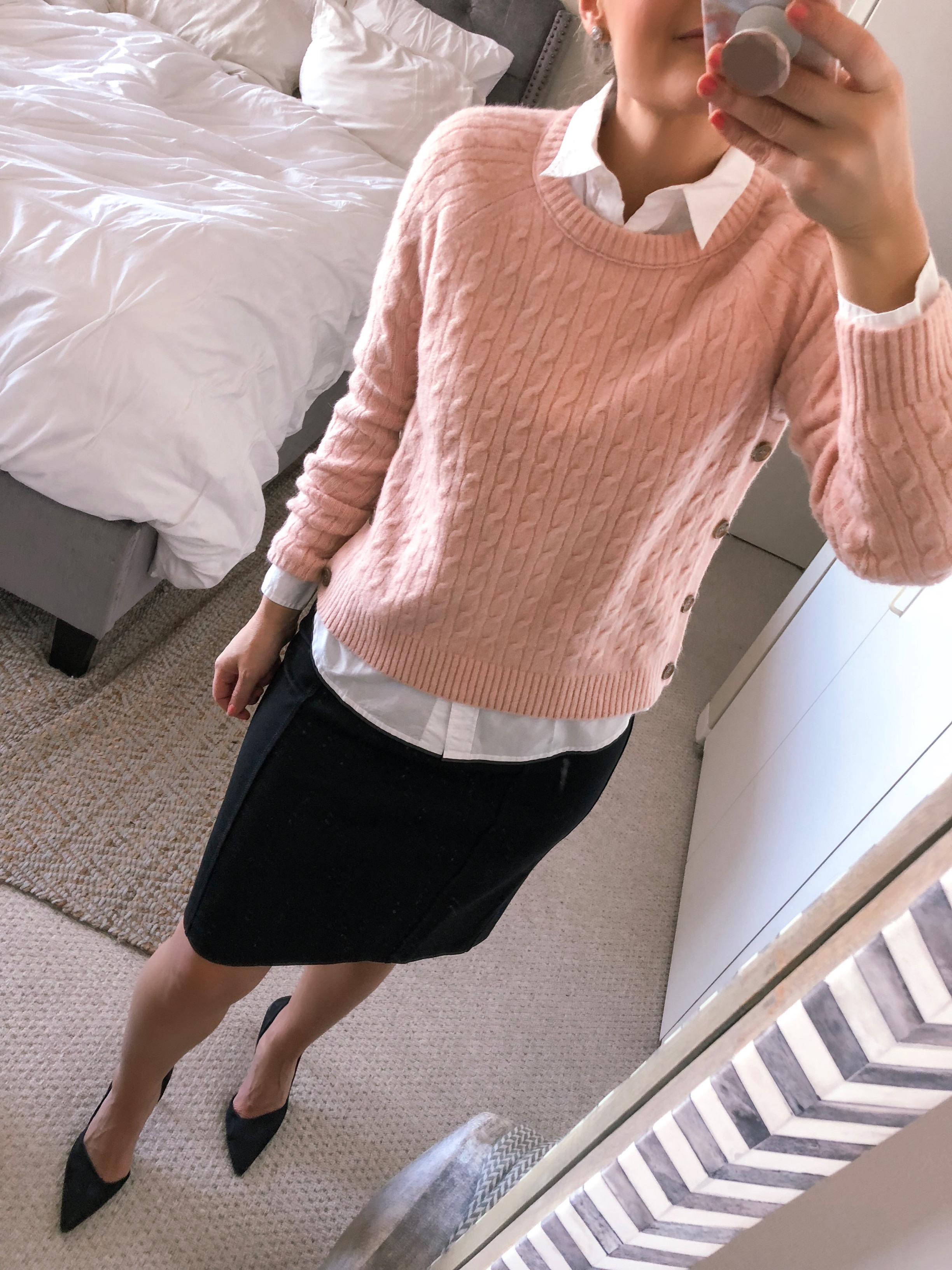pink crewneck sweater and a black pencil skirt