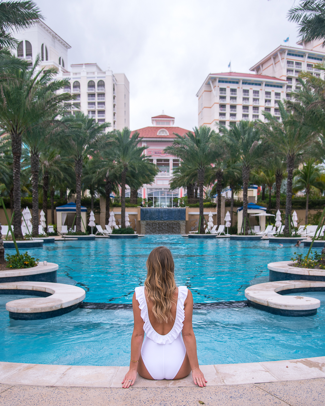 white ruffle back one piece swimsuit - baha mar resort review in the bahamas by popular Chicago travel blogger Visions of Vogue