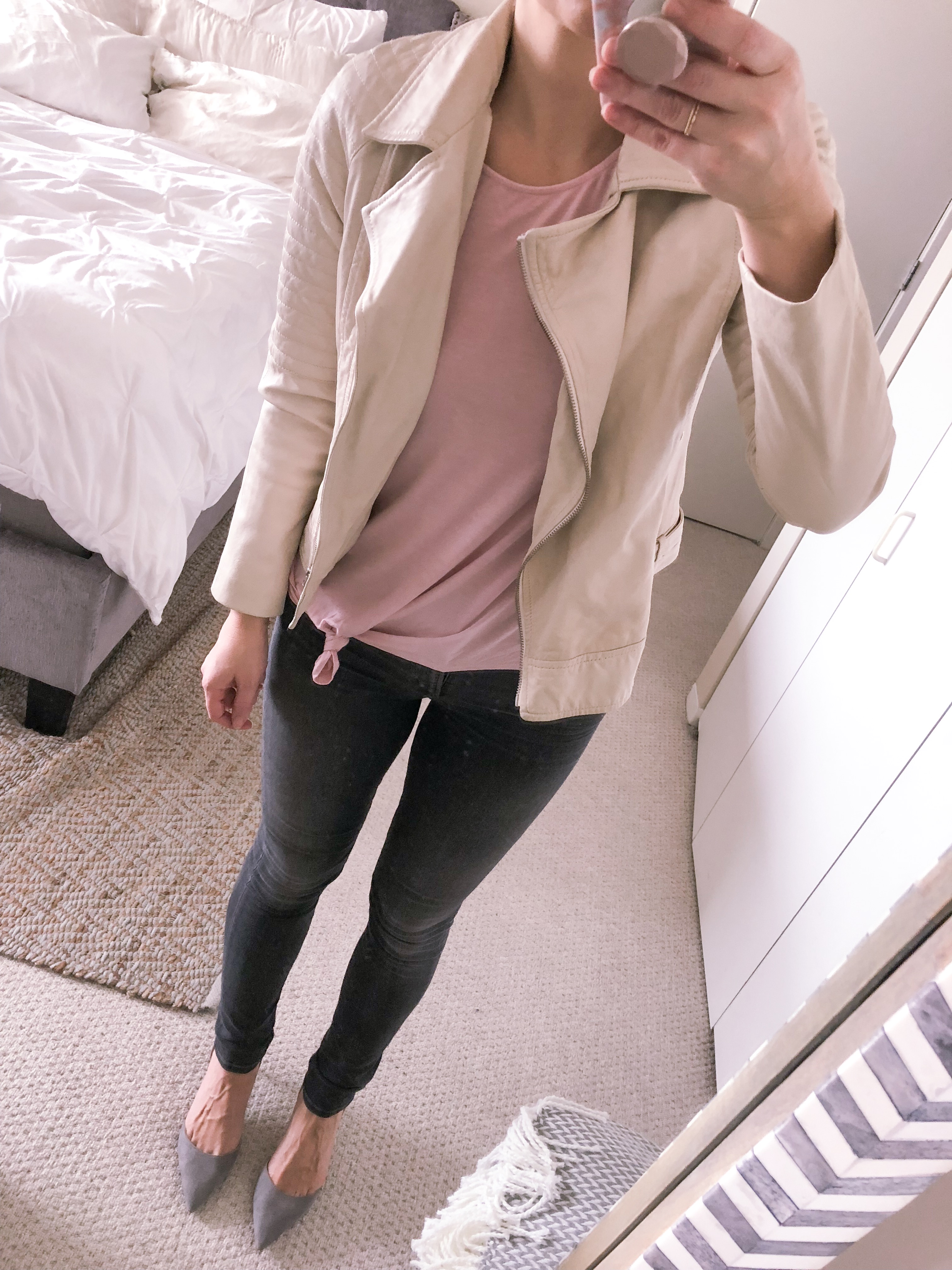 white moto jacket and a pink tee