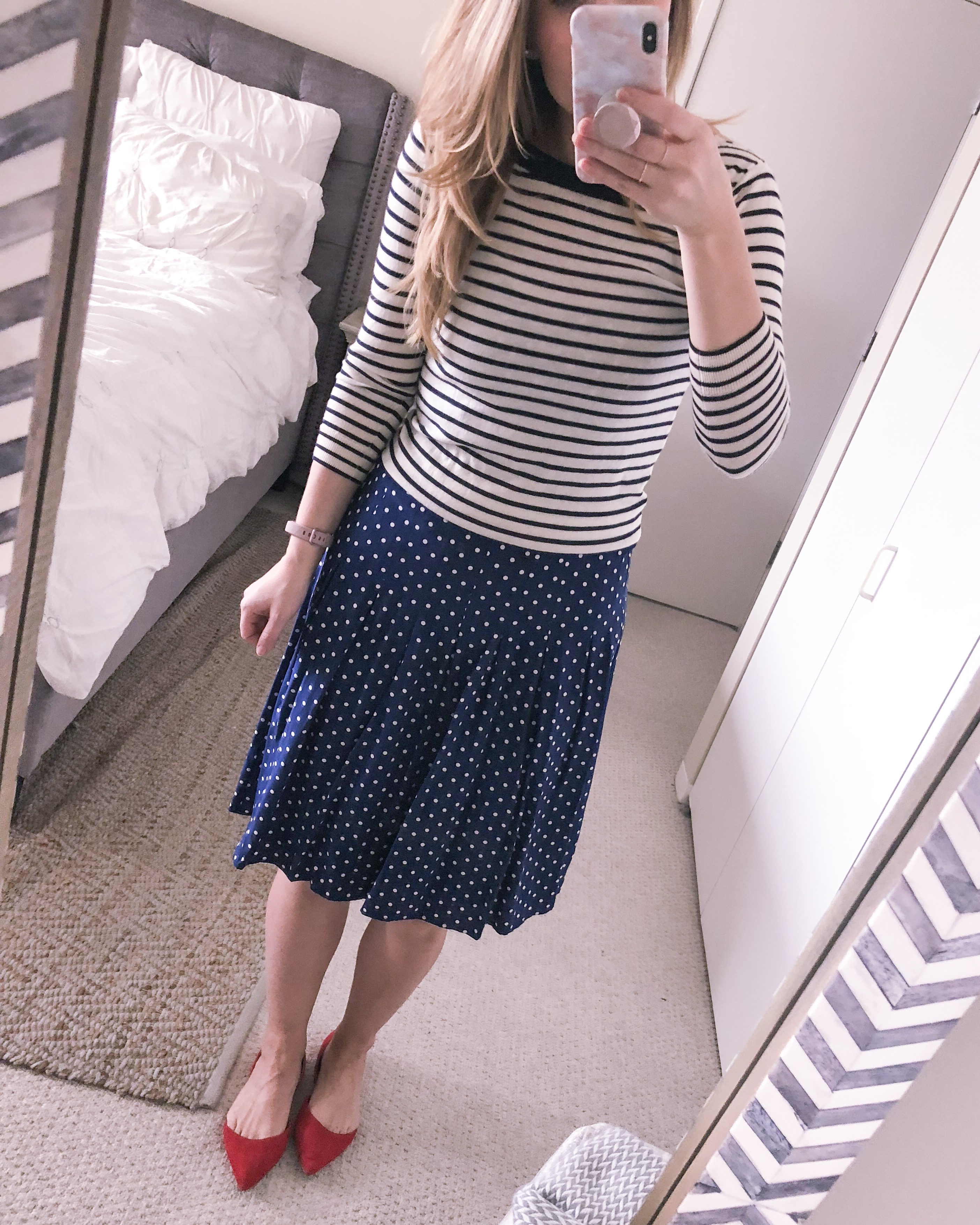 how to style a dress different ways: striped sweater and polka dot dress in navy