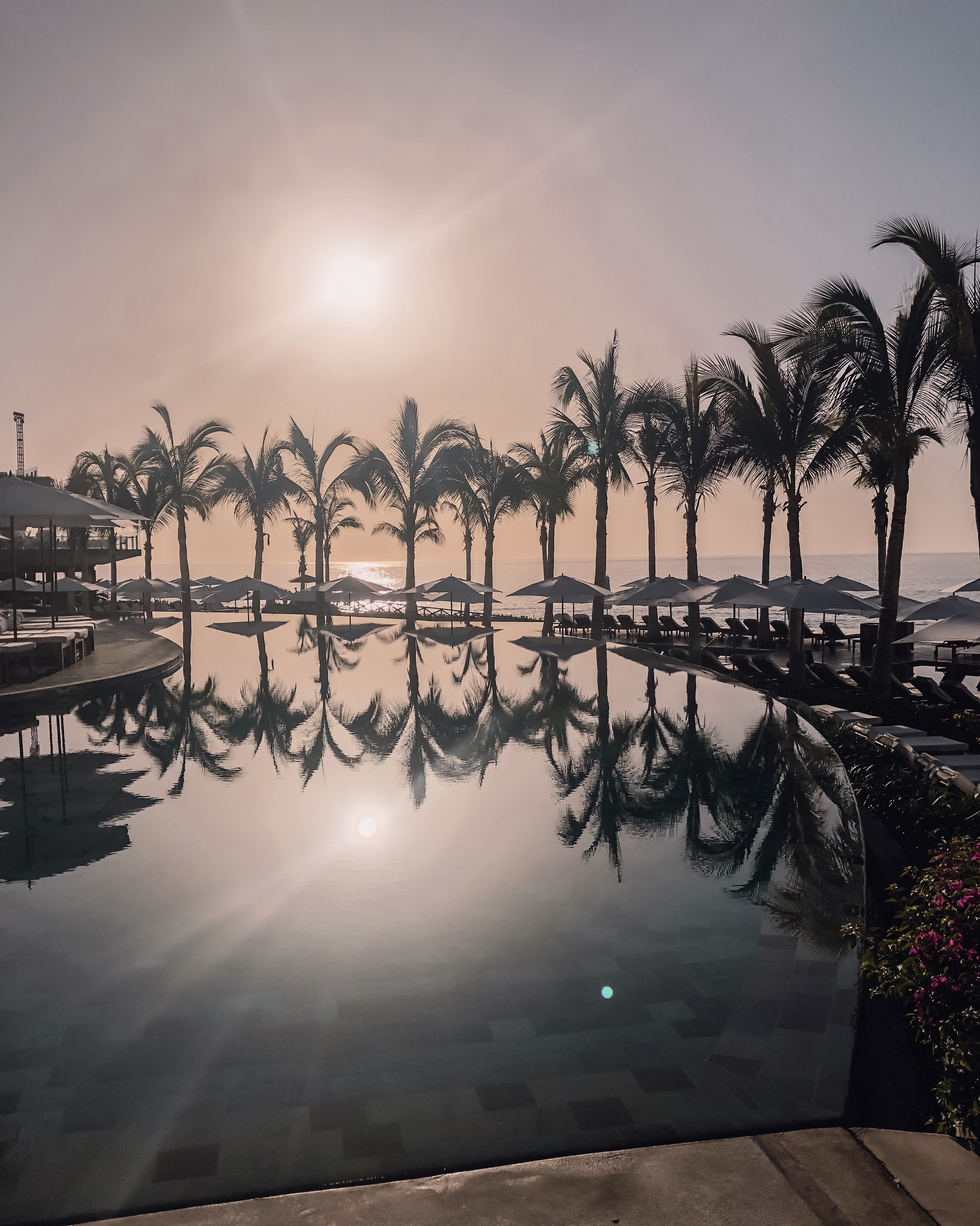 sunrise over a pool in cabo san lucas