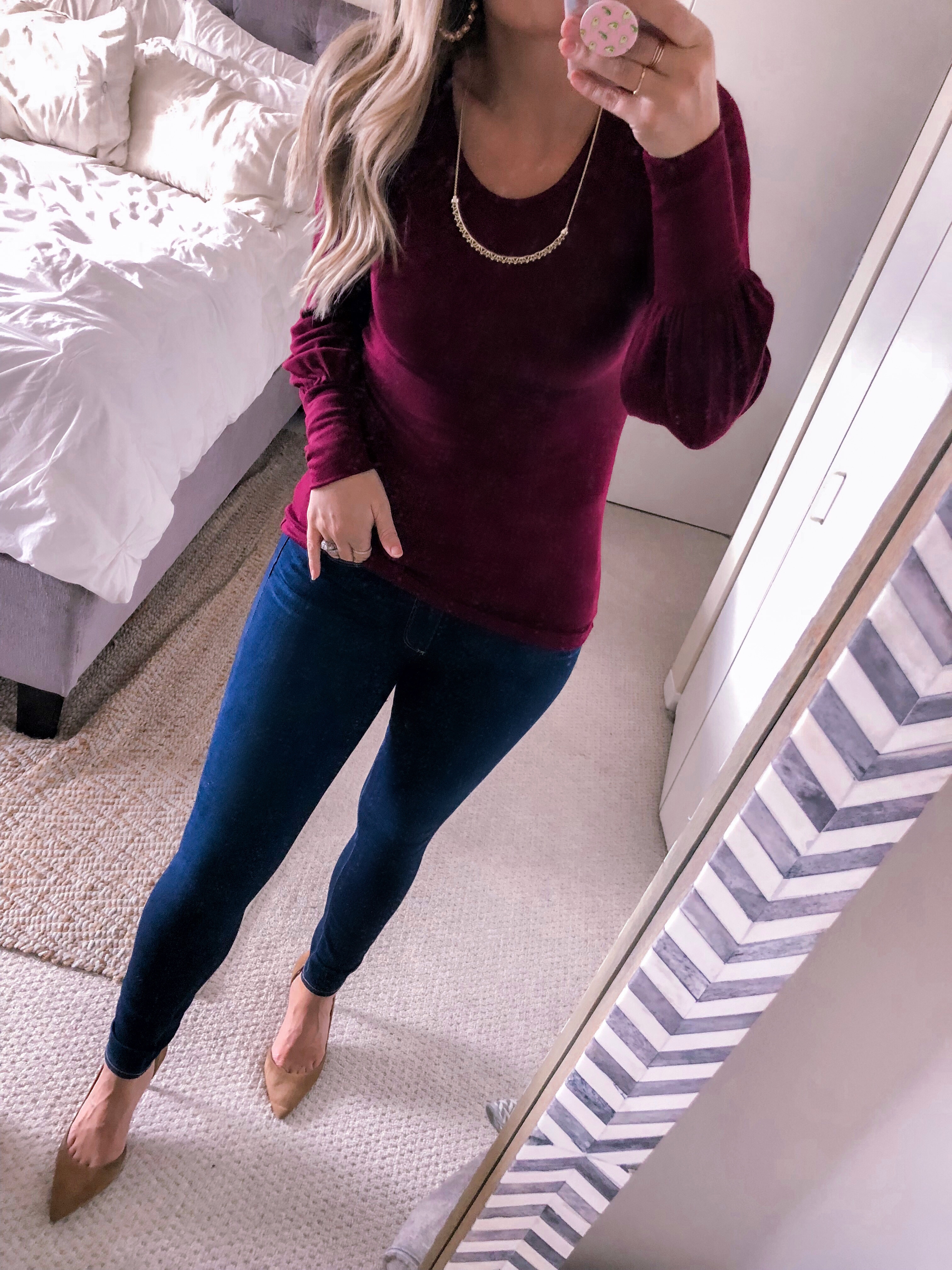 Chicago fashion blogger Visions of Vogue wears a burgundy sweater with high waist skinny jeans for a business casual outfit.