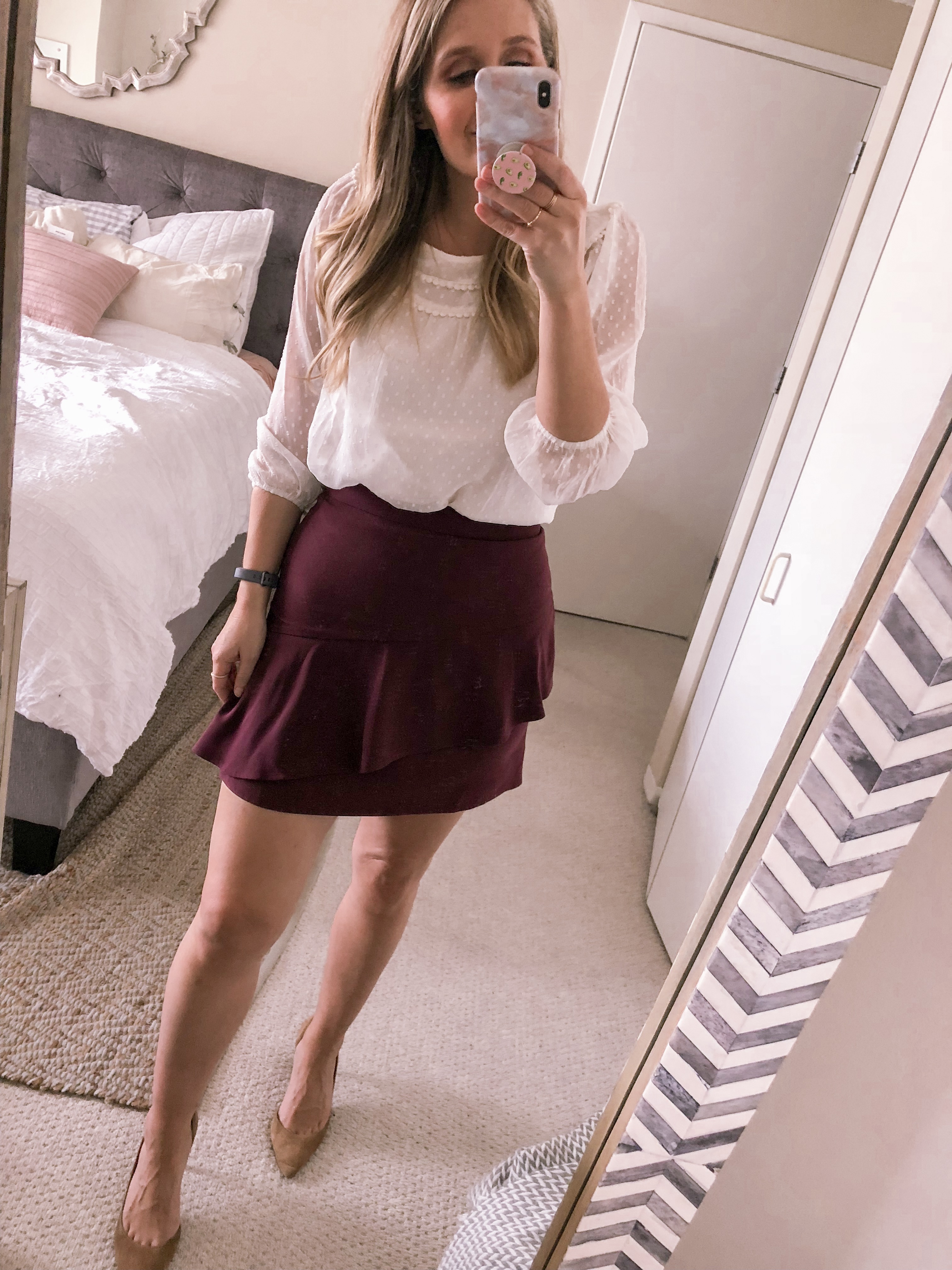 Chicago lifestyle blogger Visions of Vogue styles a LOFT pom blouse with a burgundy asymmetrial ruffled mini skirt for a fall office outfit idea.