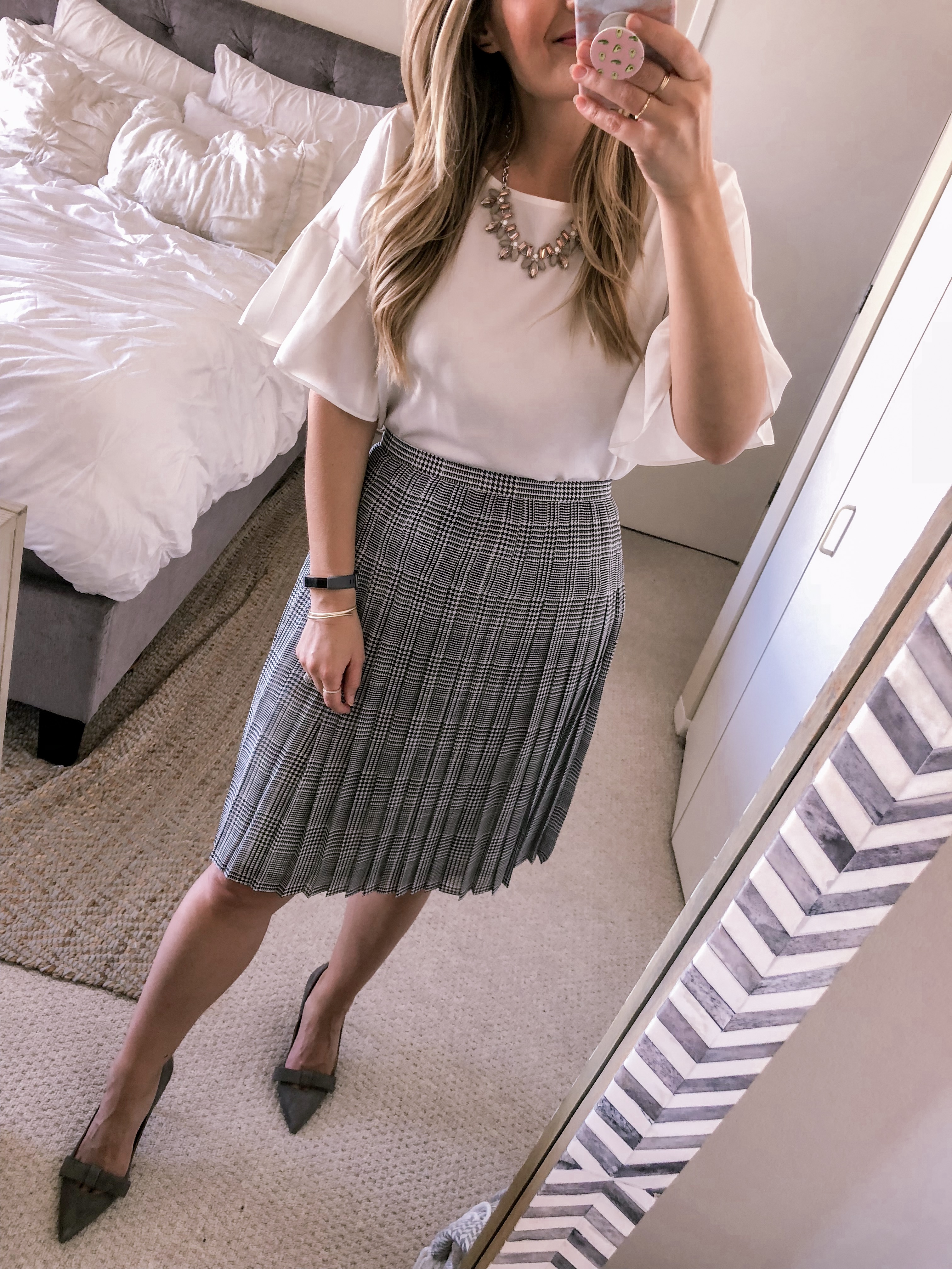 Ann Taylor Grey Pleated Midi Skirt with a white ruffled blouse.