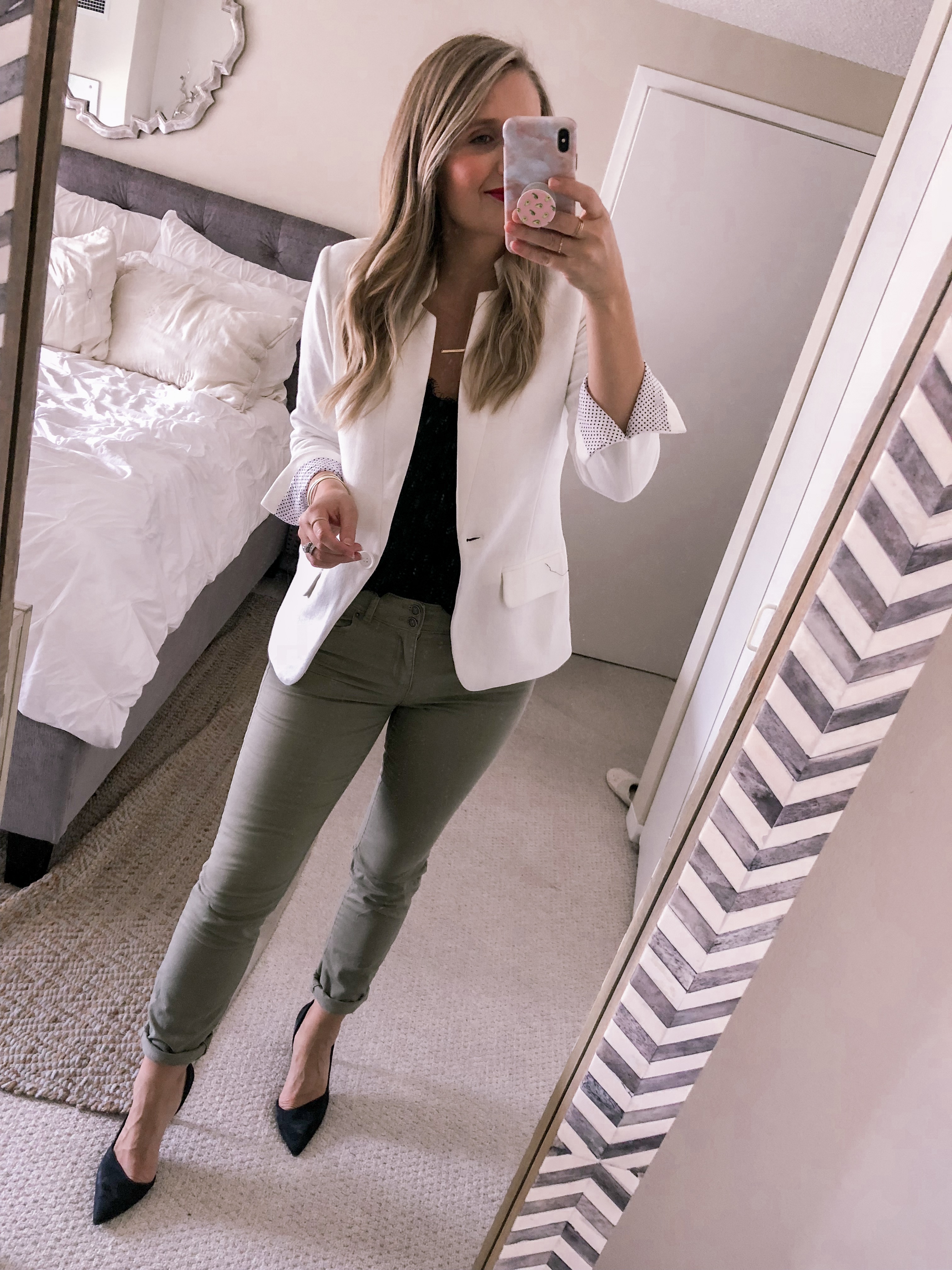 Jenna Colgrove styles a white blazer with olive pants and black pumps for a work outfit idea this fall.