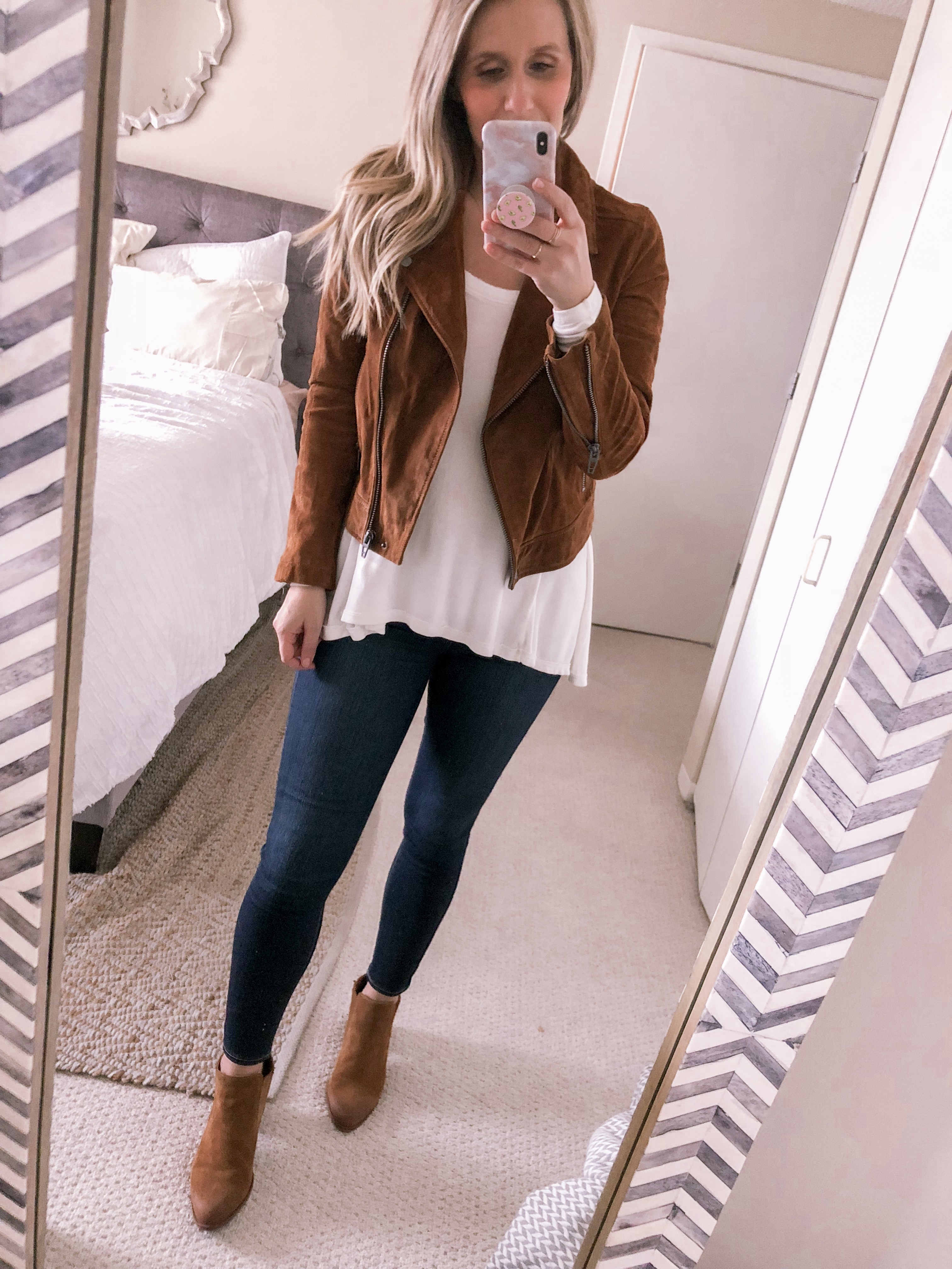 Popular Chicago fashion blogger Visions of Vogue styles a suede moto jacket with the Free People January tee for under $50 as an office casual outfit idea.
