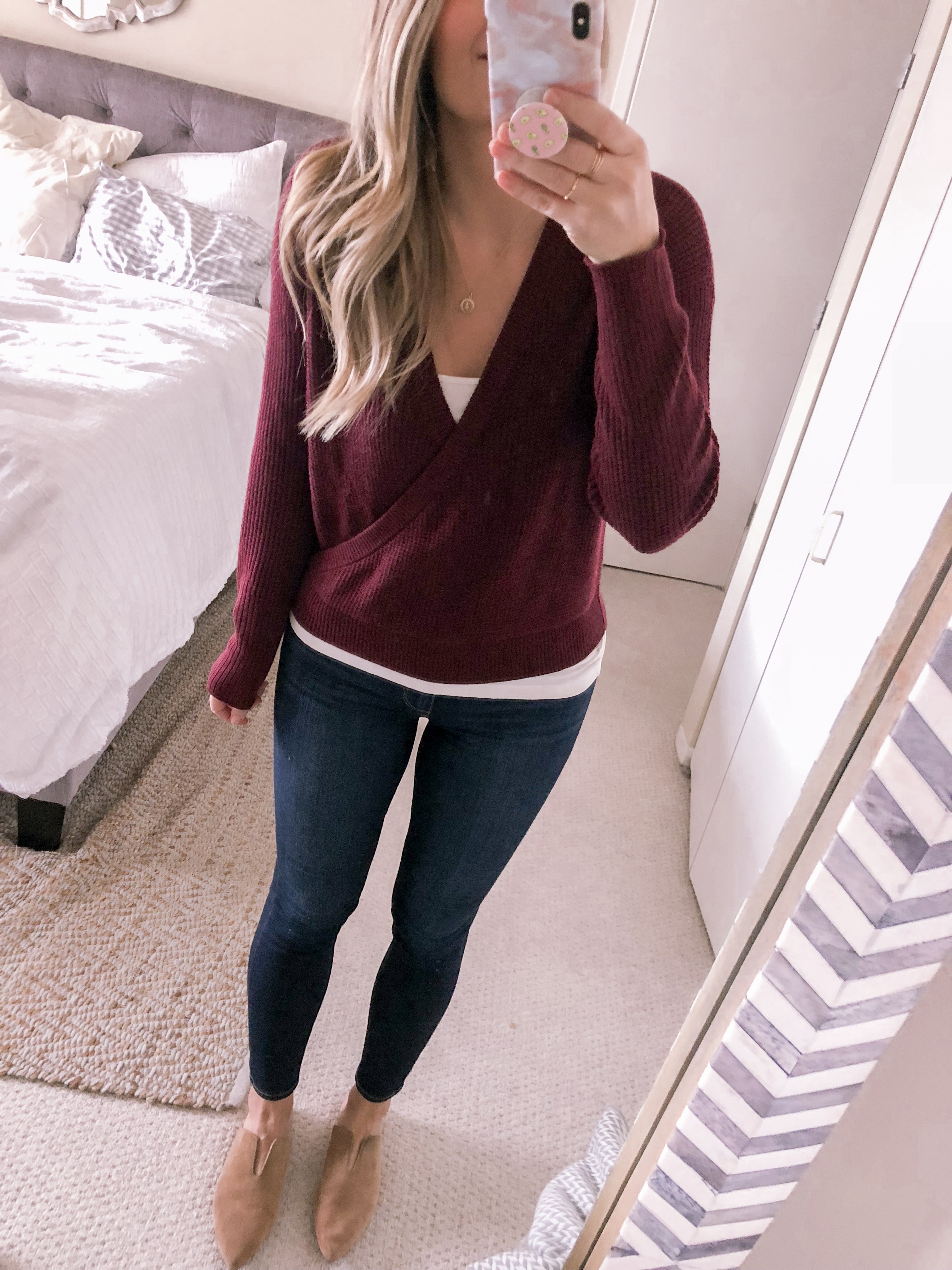 Jenna Colgrove styles a burgundy wrap sweater for the office as a work outfit idea for fall.