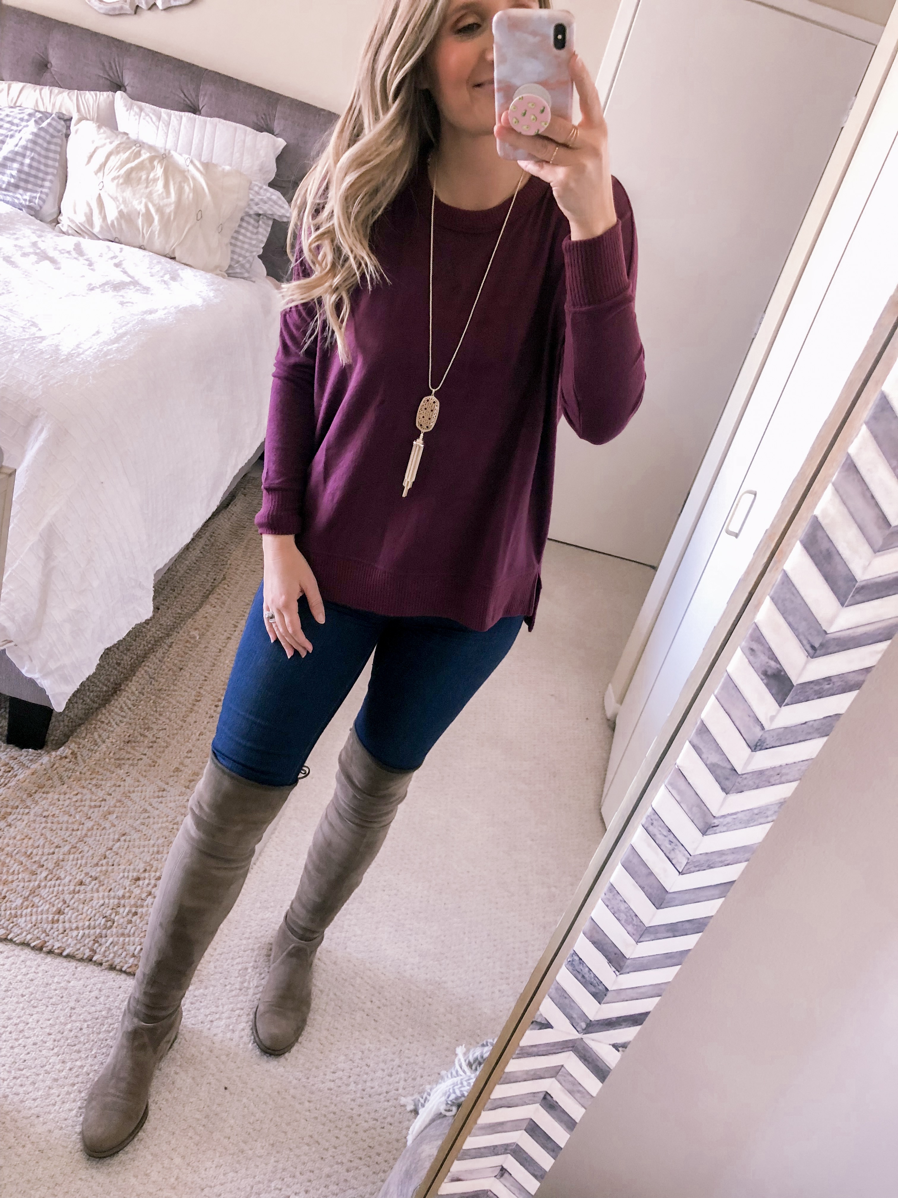 Popular Chicago fashion blogger, Jenna Colgrove, shares a burgundy tunic sweater with high waist skinny jeans for a business casual office outfit idea.