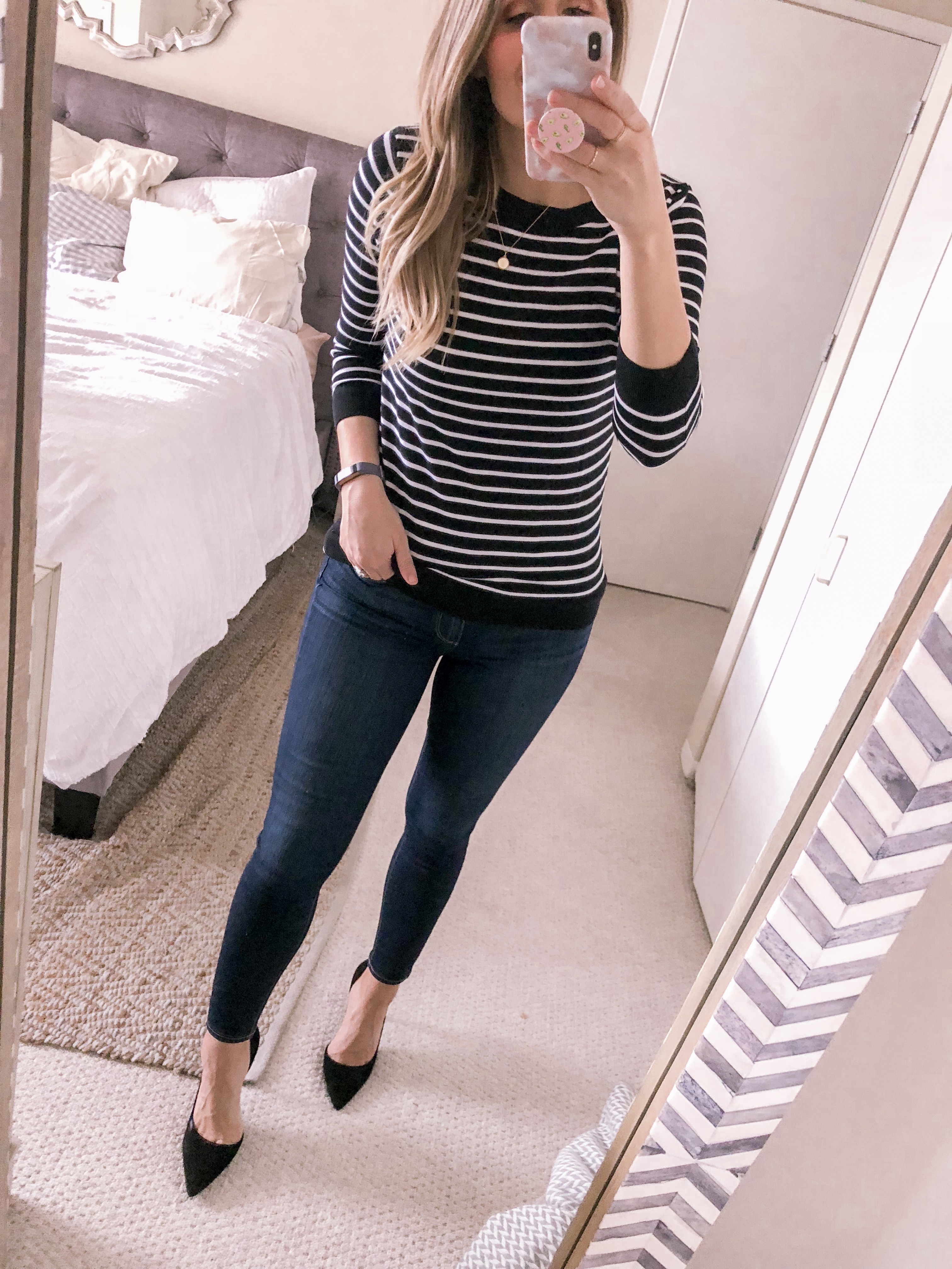 Chicago fashion blogger Visions of Vogue styles a black striped sweater with black suede heels for a dressy business casual outfit idea.