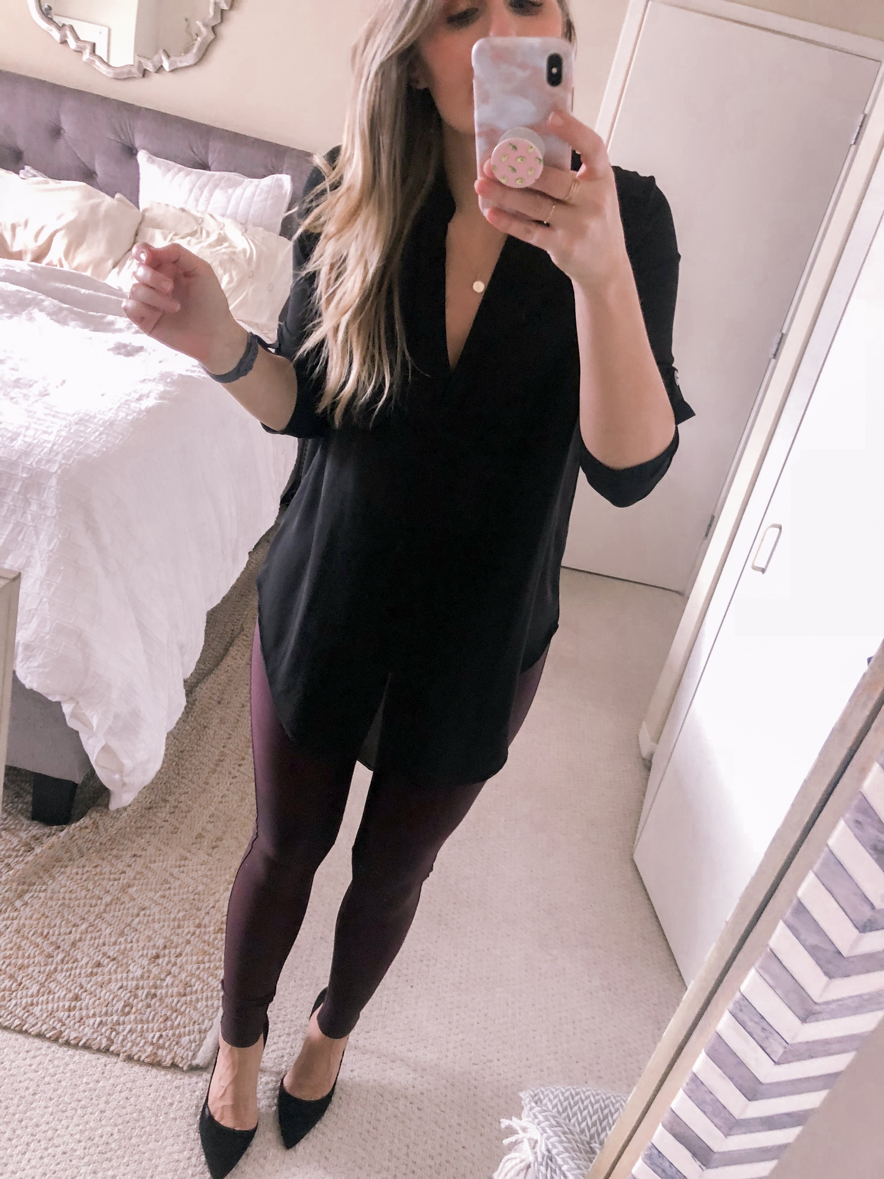 Popular Chicago fashion blogger styles the Spanx Faux Leather Leggings in burgundy with a black tunic for under $25 for a office outfit idea.