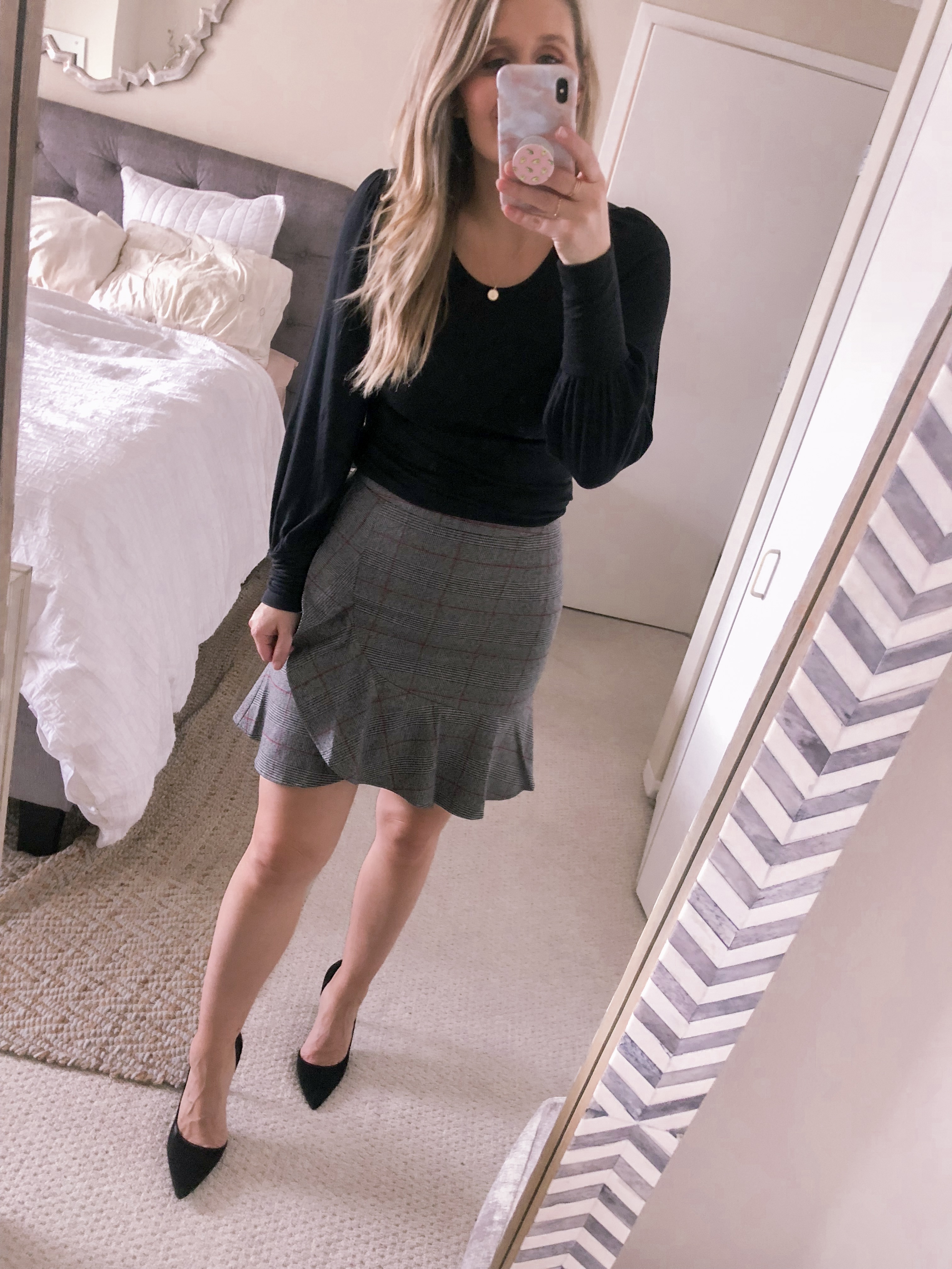 grey plaid skirt and black sweater