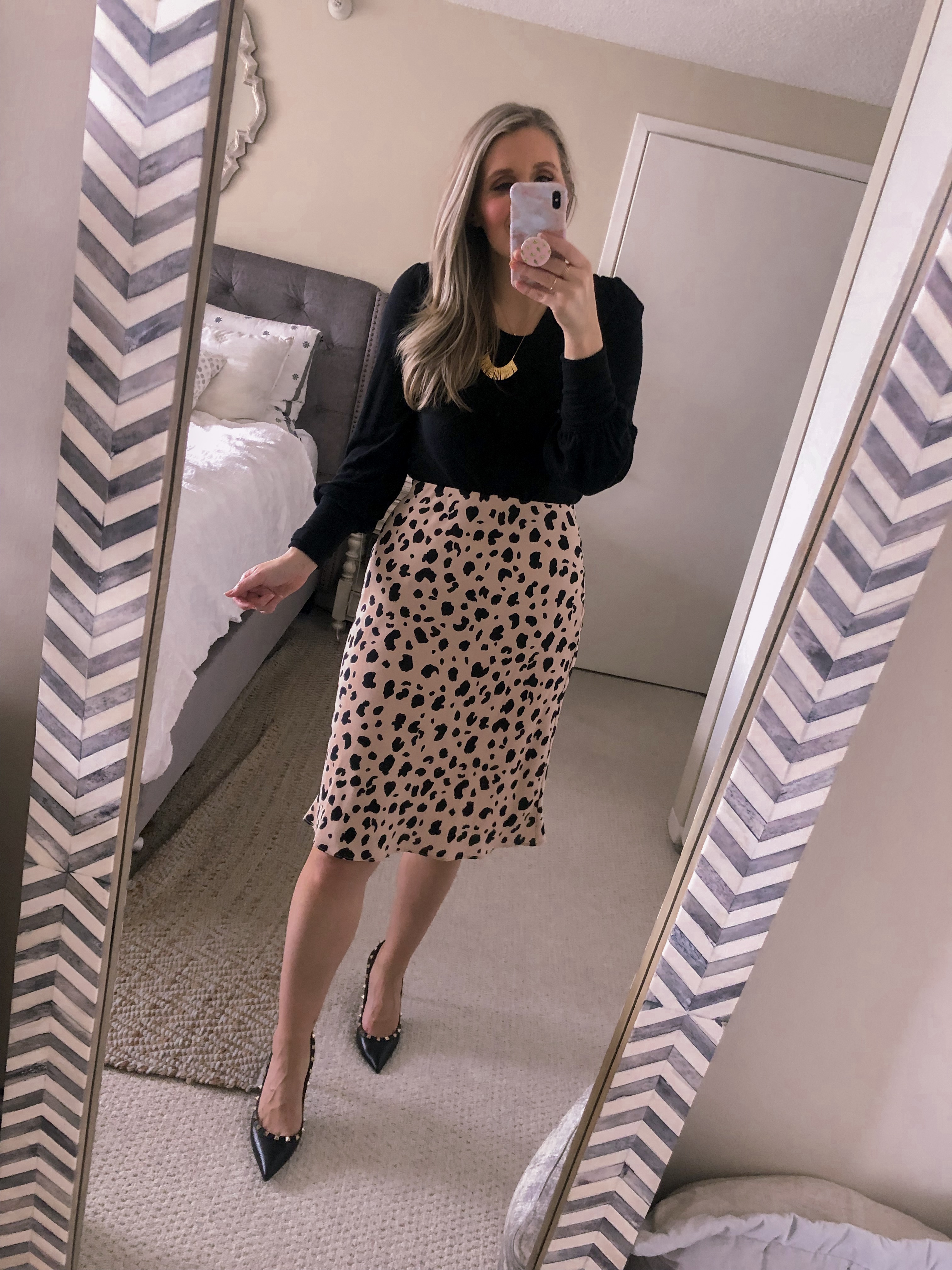 long sleeve black top with a leopard midi skirt 