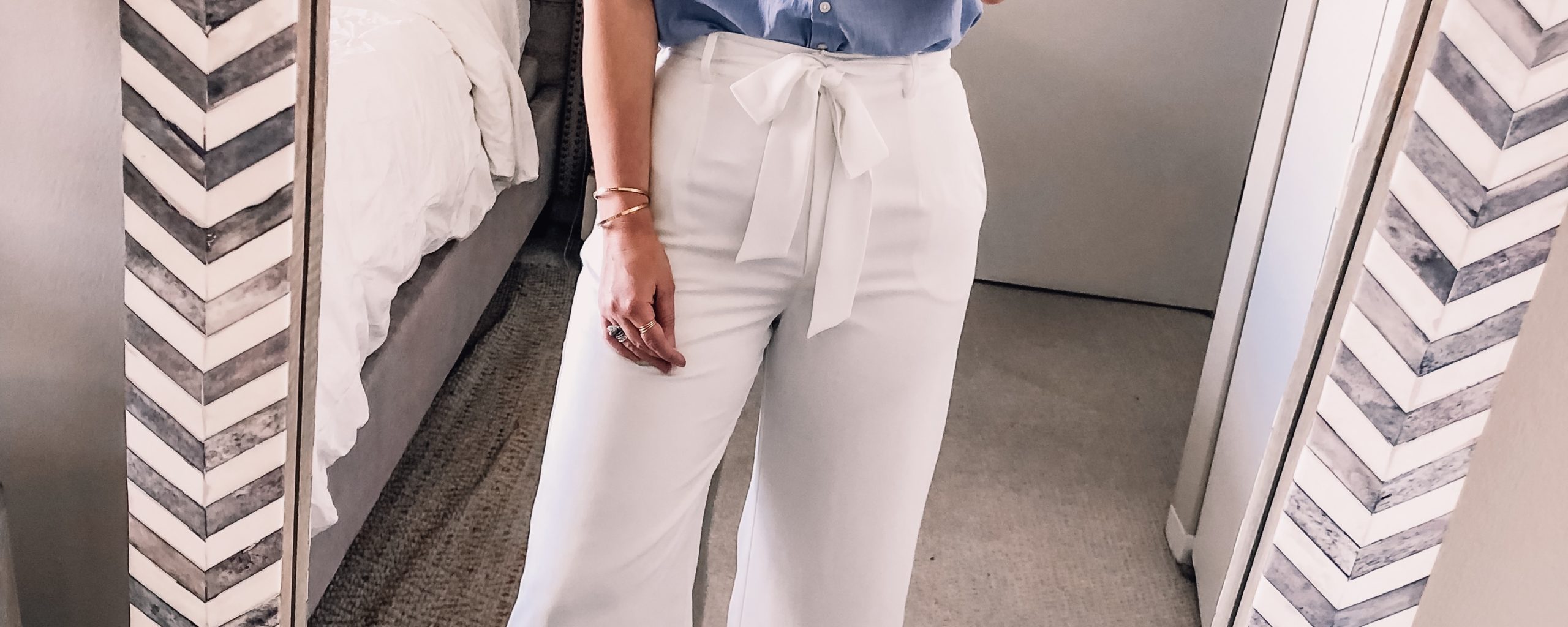 white wide leg pants and a blue button down shirt