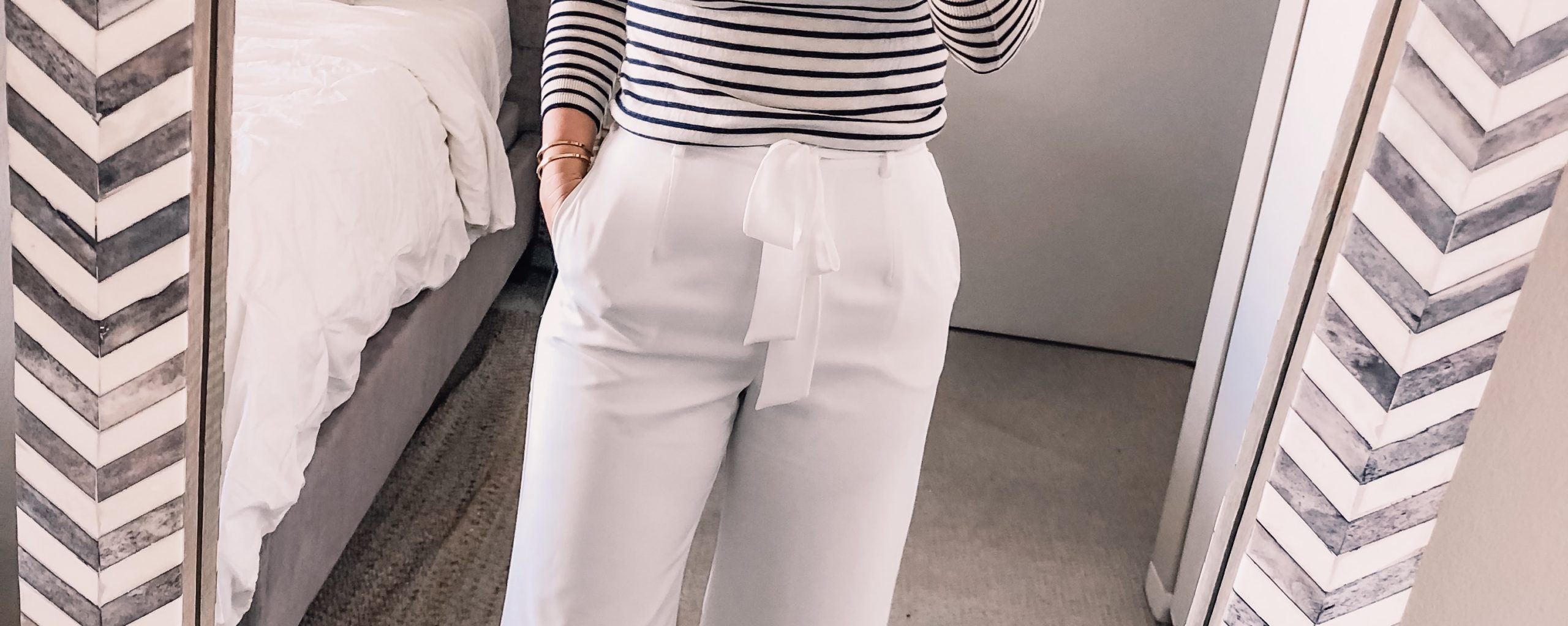 white pants and a striped sweater