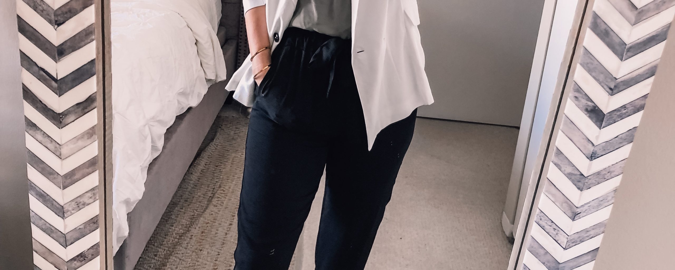 white blazer, black work pants, and green lace top